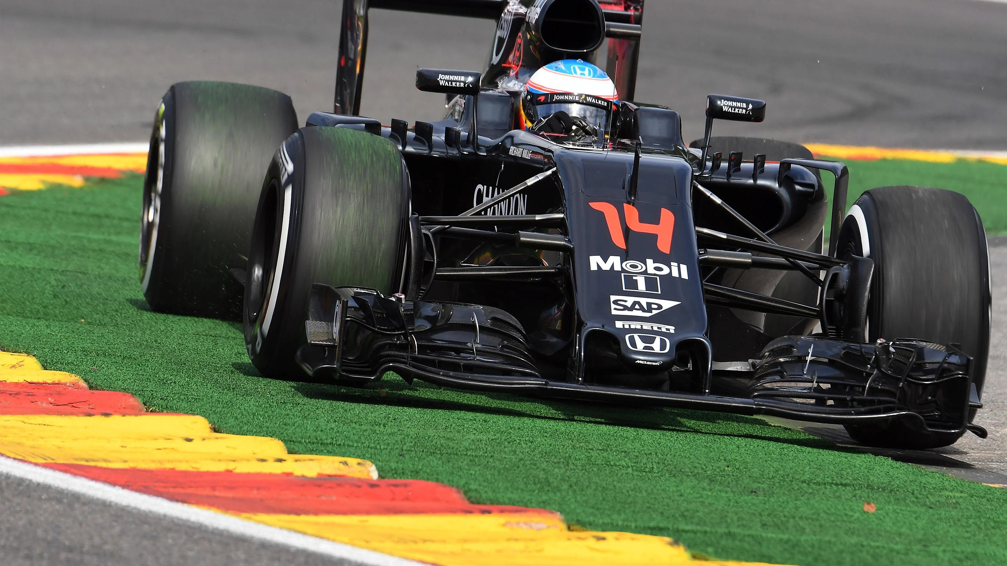 Fernando Alonso (ESP) McLaren MP4-31 runs wide at Formula One World Championship, Rd13, Belgian