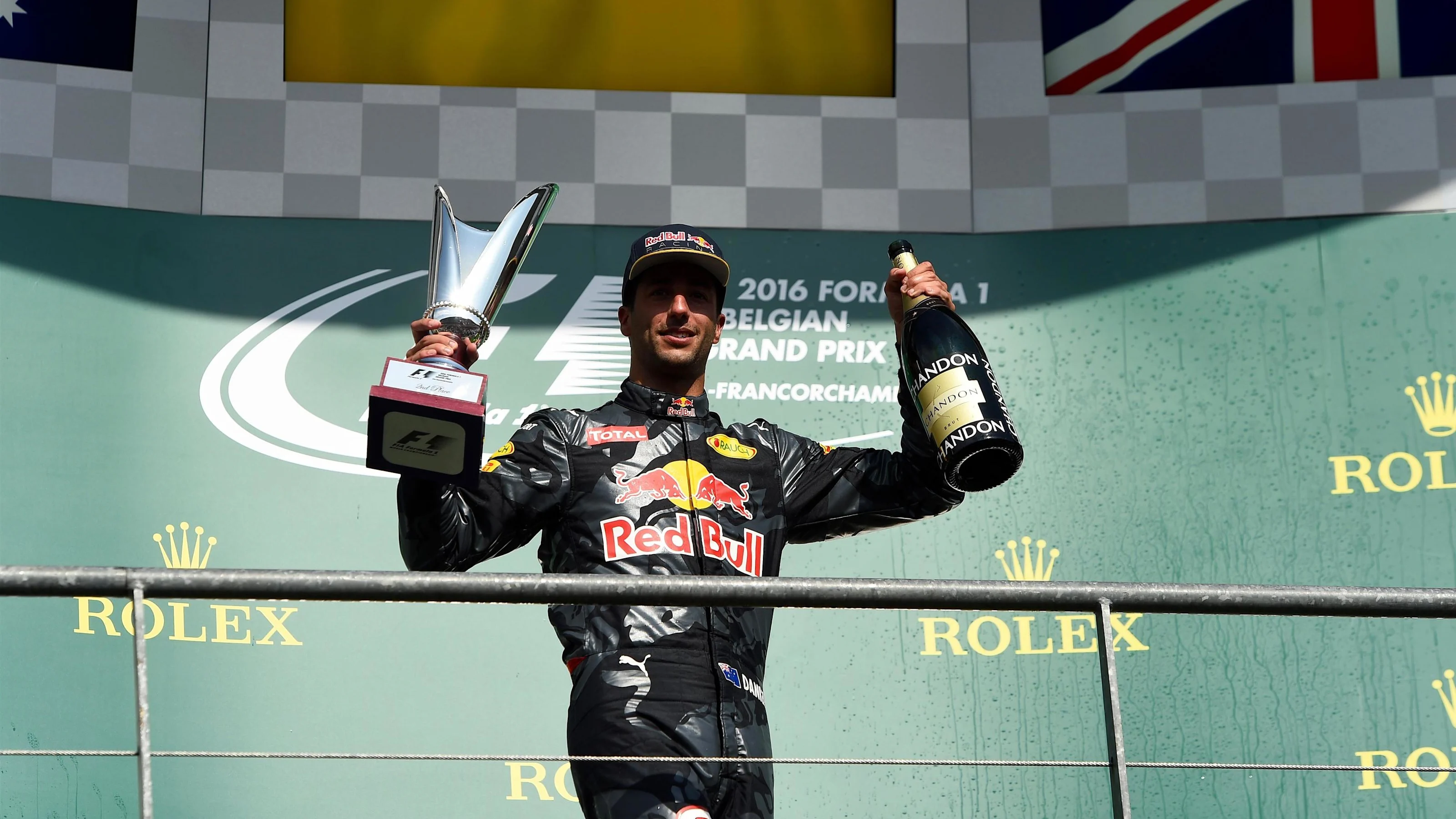 Daniel Ricciardo (AUS) Red Bull Racing celebrates on the podium with the champagne and the trophy