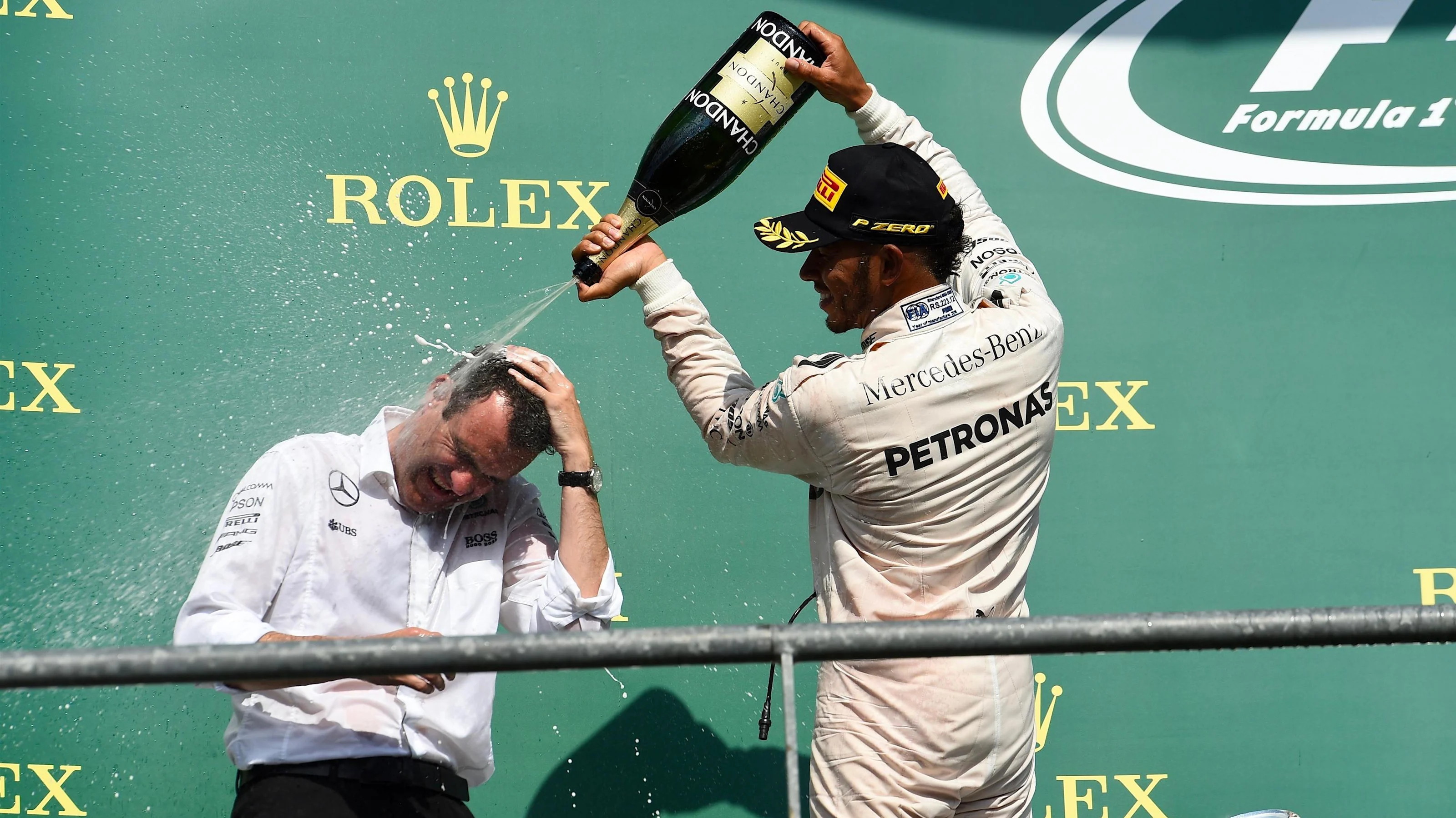 Hywel Thomas (GBR) Mercedes AMG F1 and Lewis Hamilton (GBR) Mercedes AMG F1 celebrate on the podium
