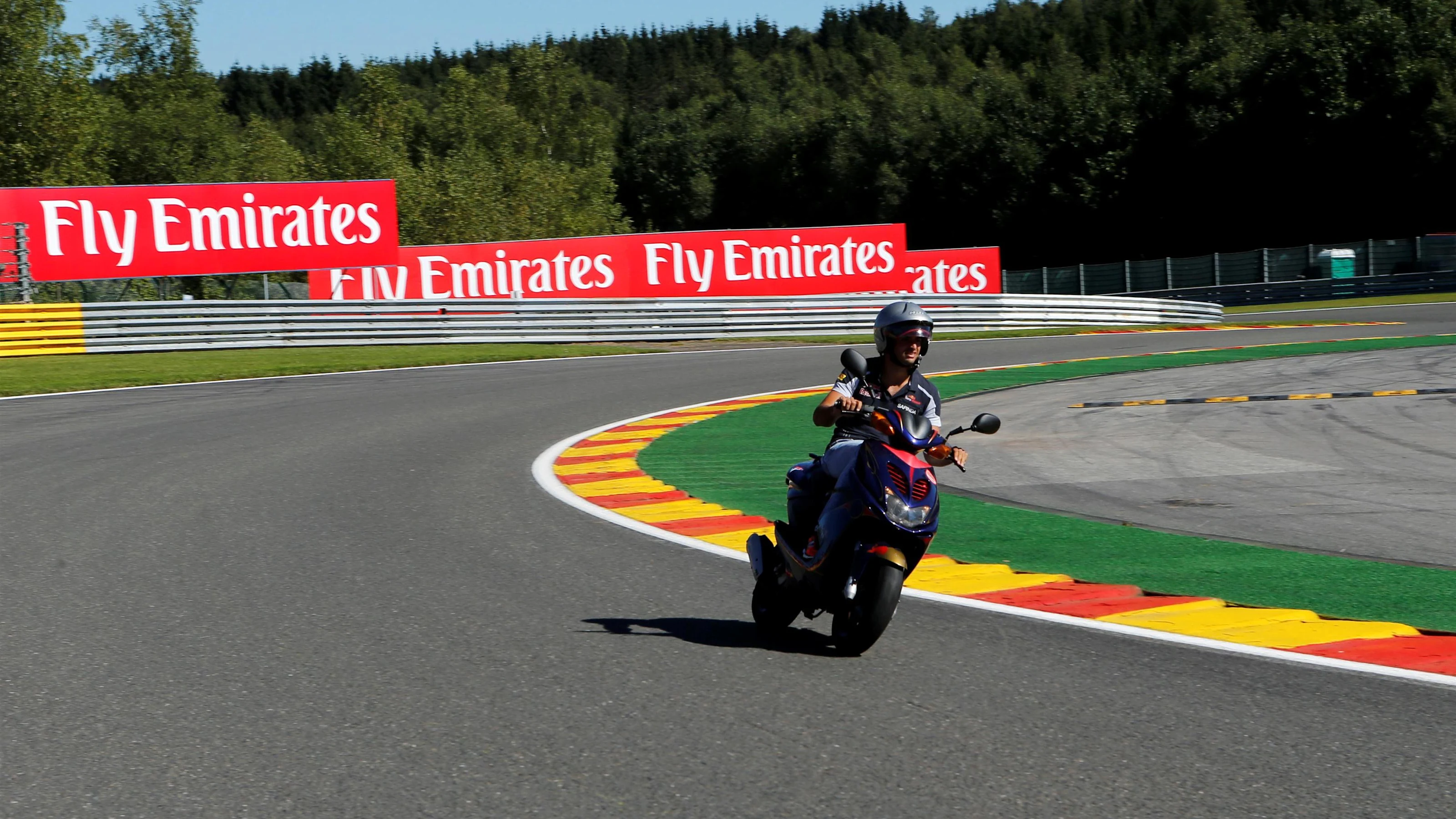 Carlos Sainz jr (ESP) Scuderia Toro Rosso rides the track on a scooter at Formula One World