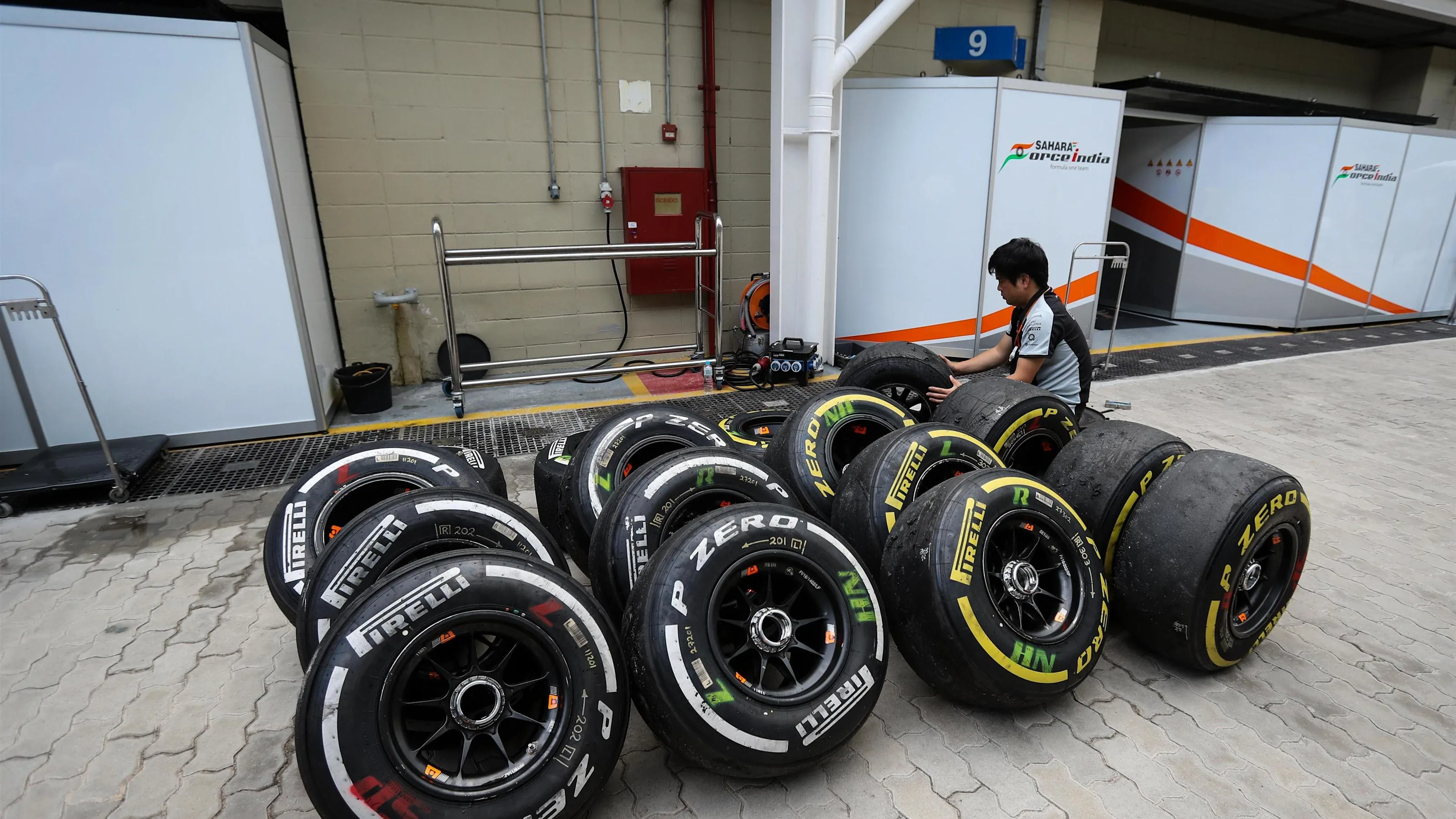 Force India Mechanic with Pirelli tyres at Formula One World Championship, Rd20, Brazilian Grand