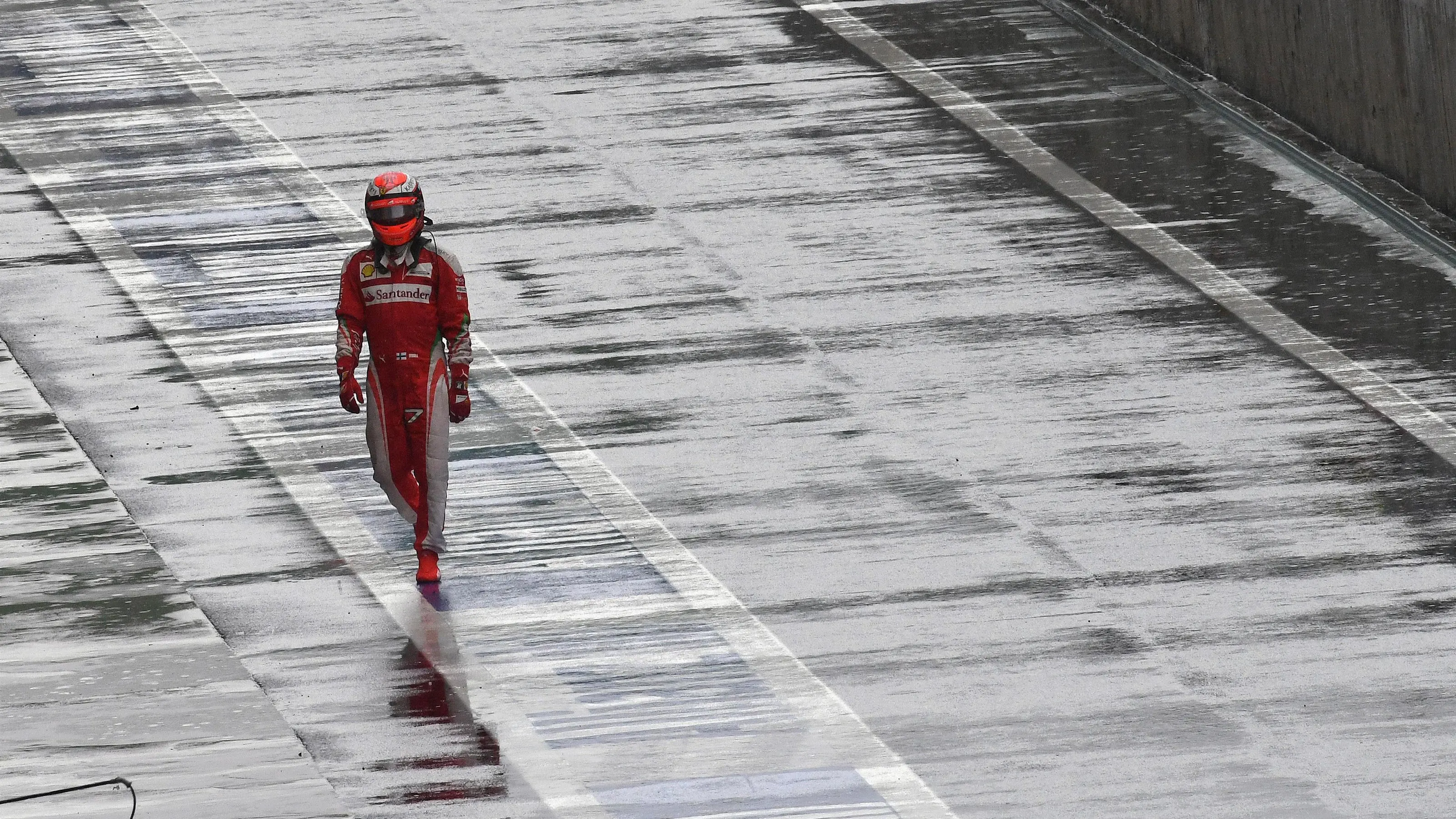 Race retiree Kimi Raikkonen (FIN) Ferrari walks in at Formula One World Championship, Rd20,
