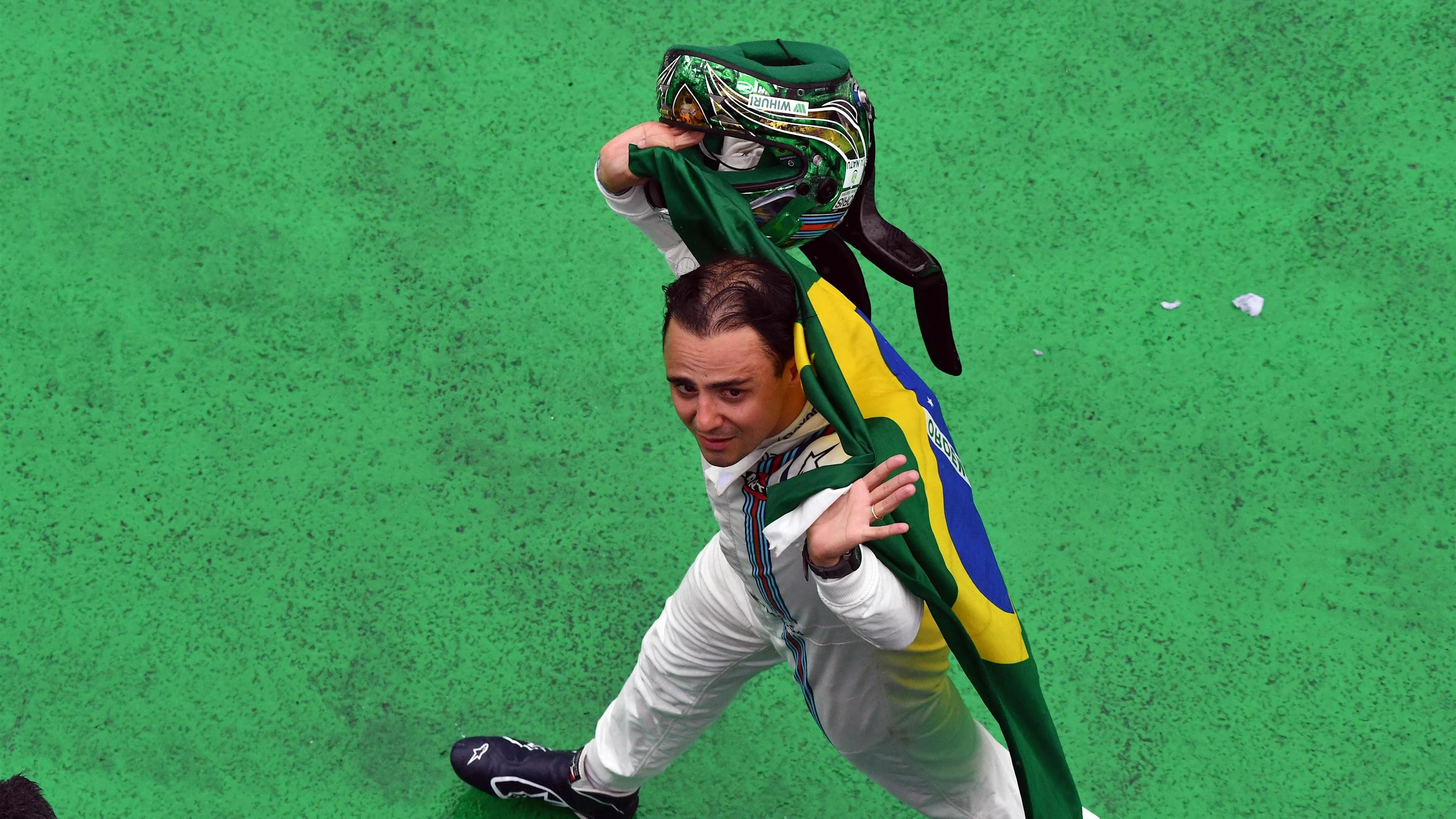Race retiree Felipe Massa (BRA) Williams walks in with Brazlian flag at Formula One World