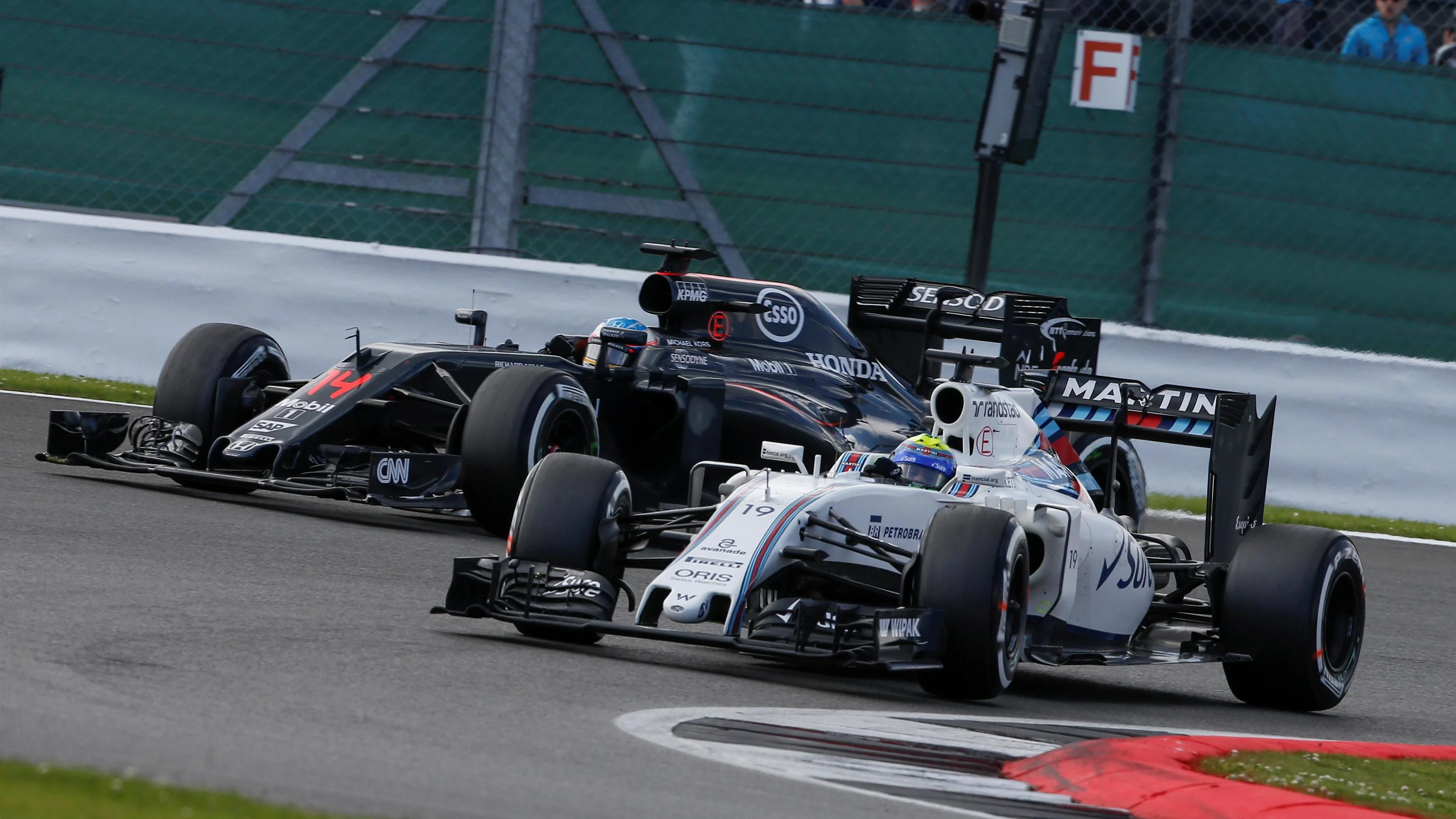 Fernando Alonso (ESP) McLaren MP4-31 and Valtteri Bottas (FIN) Williams FW38 battle for position at