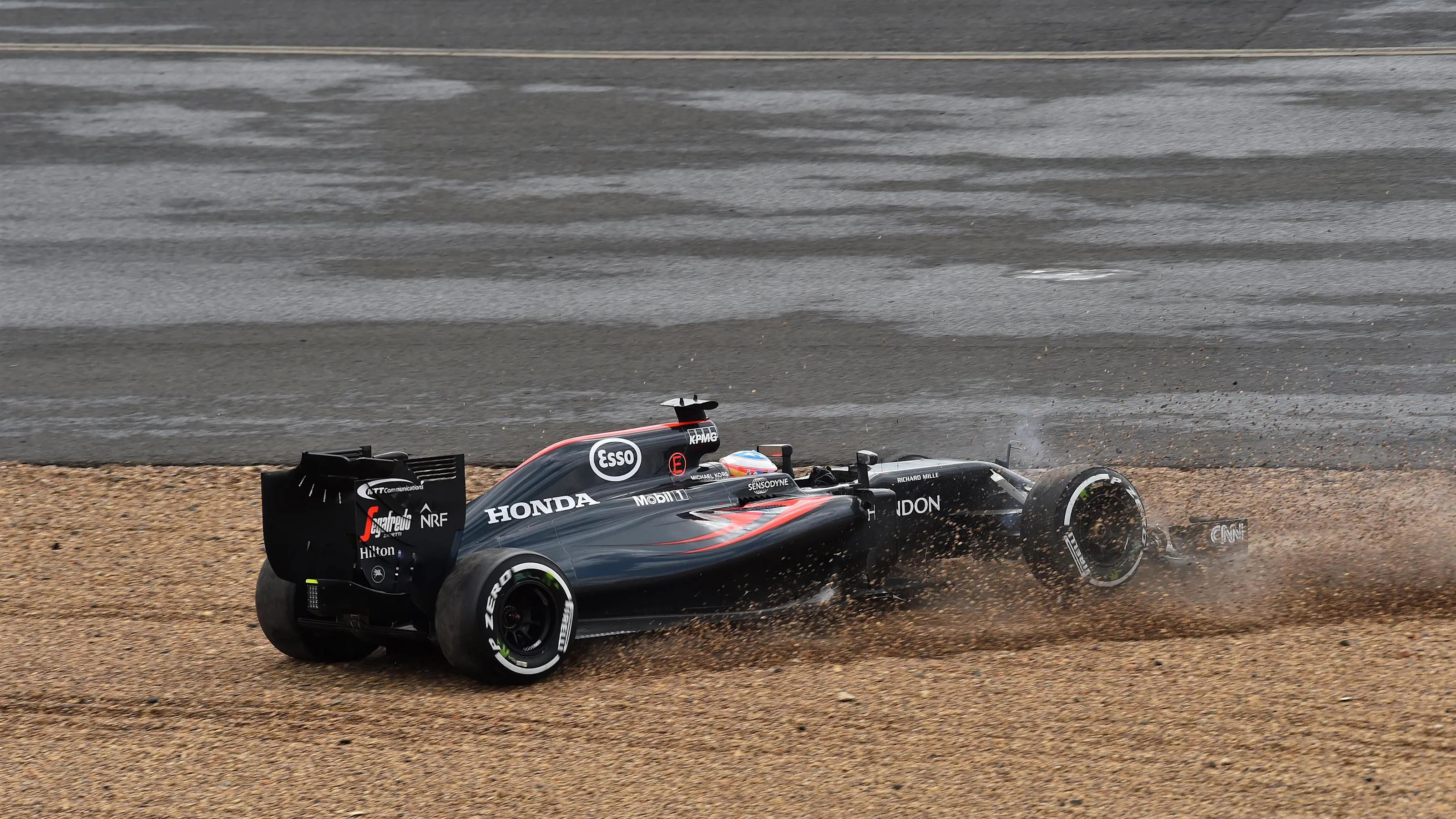 Fernando Alonso (ESP) McLaren MP4-31 spins at Formula One World Championship, Rd10, British Grand