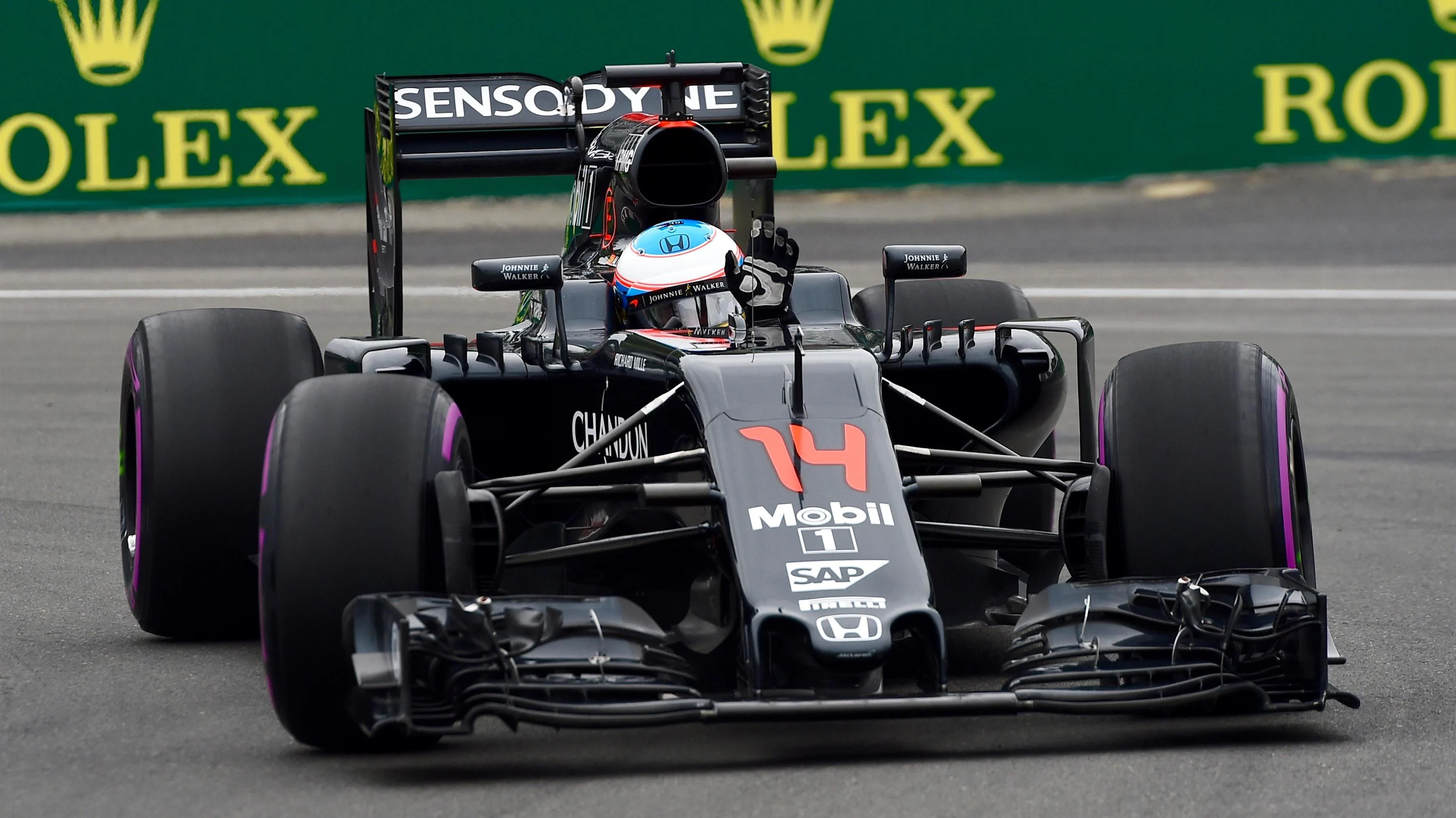 Fernando Alonso (ESP) McLaren MP4-31 waves to the crowd at Formula One World Championship, Rd7,
