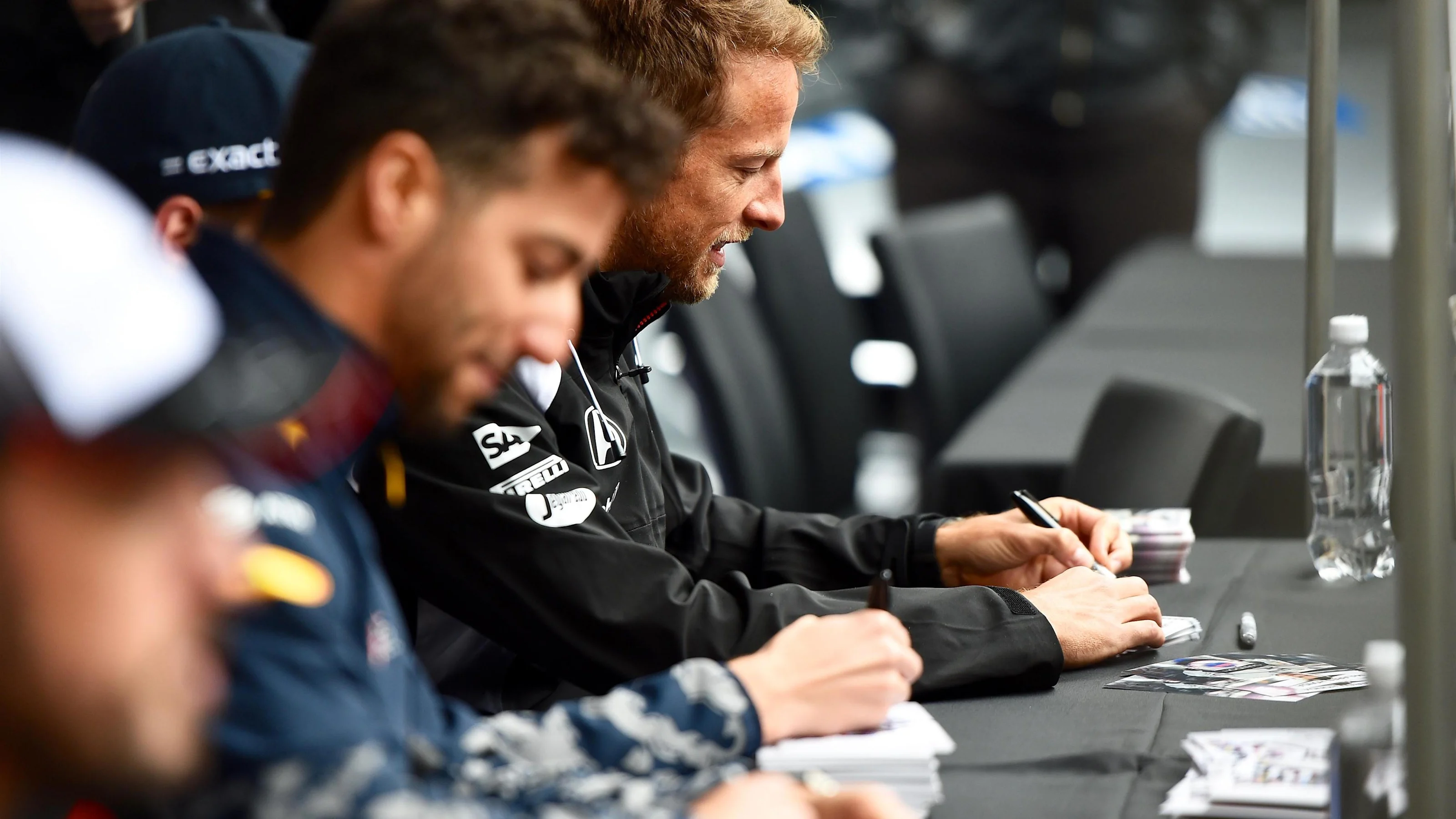 Jenson Button (GBR) McLaren and Daniel Ricciardo (AUS) Red Bull Racing at the autograph session at