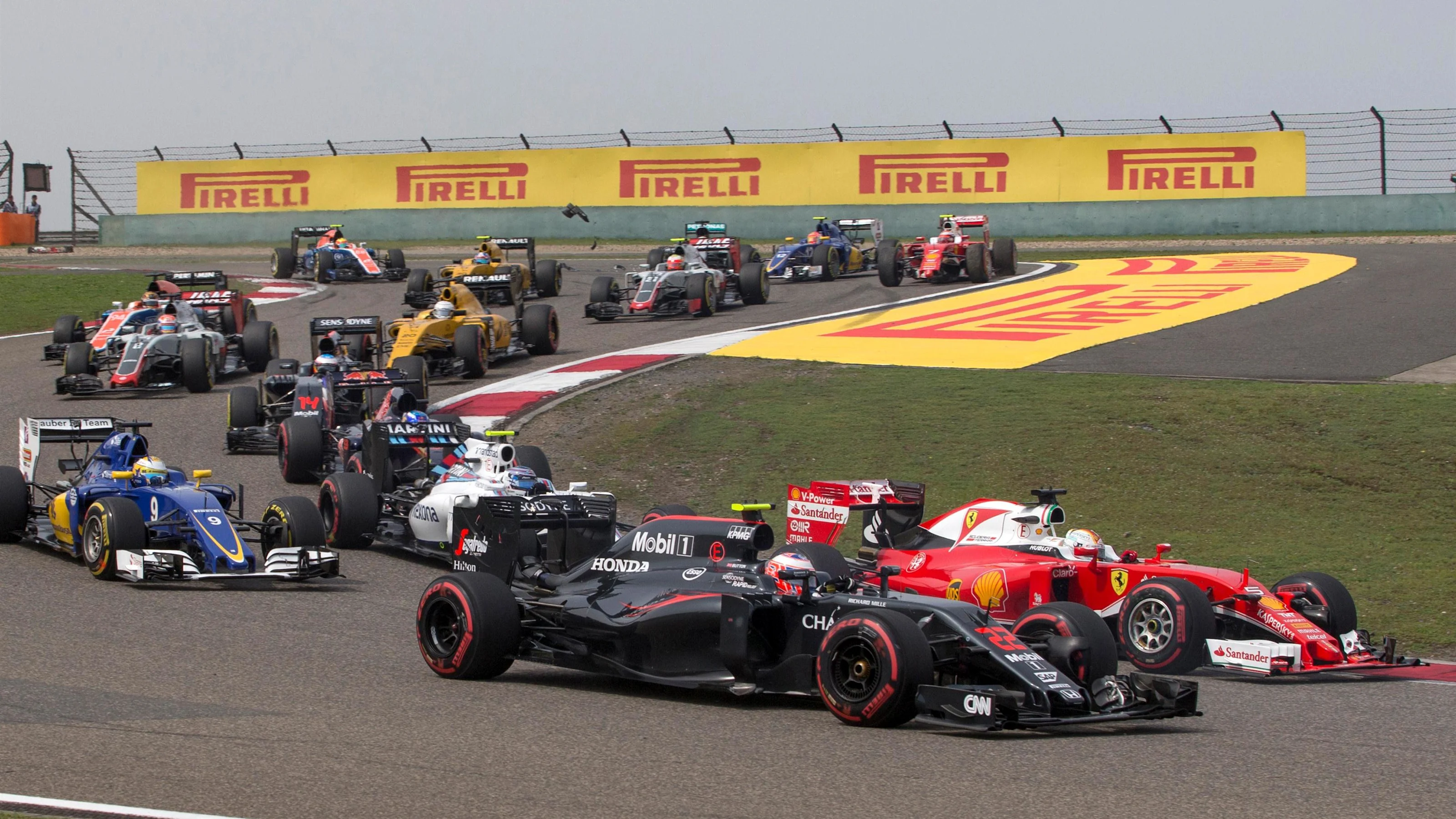 Jenson Button (GBR) McLaren MP4-31 and Sebastian Vettel (GER) Ferrari SF16-H at the start of the