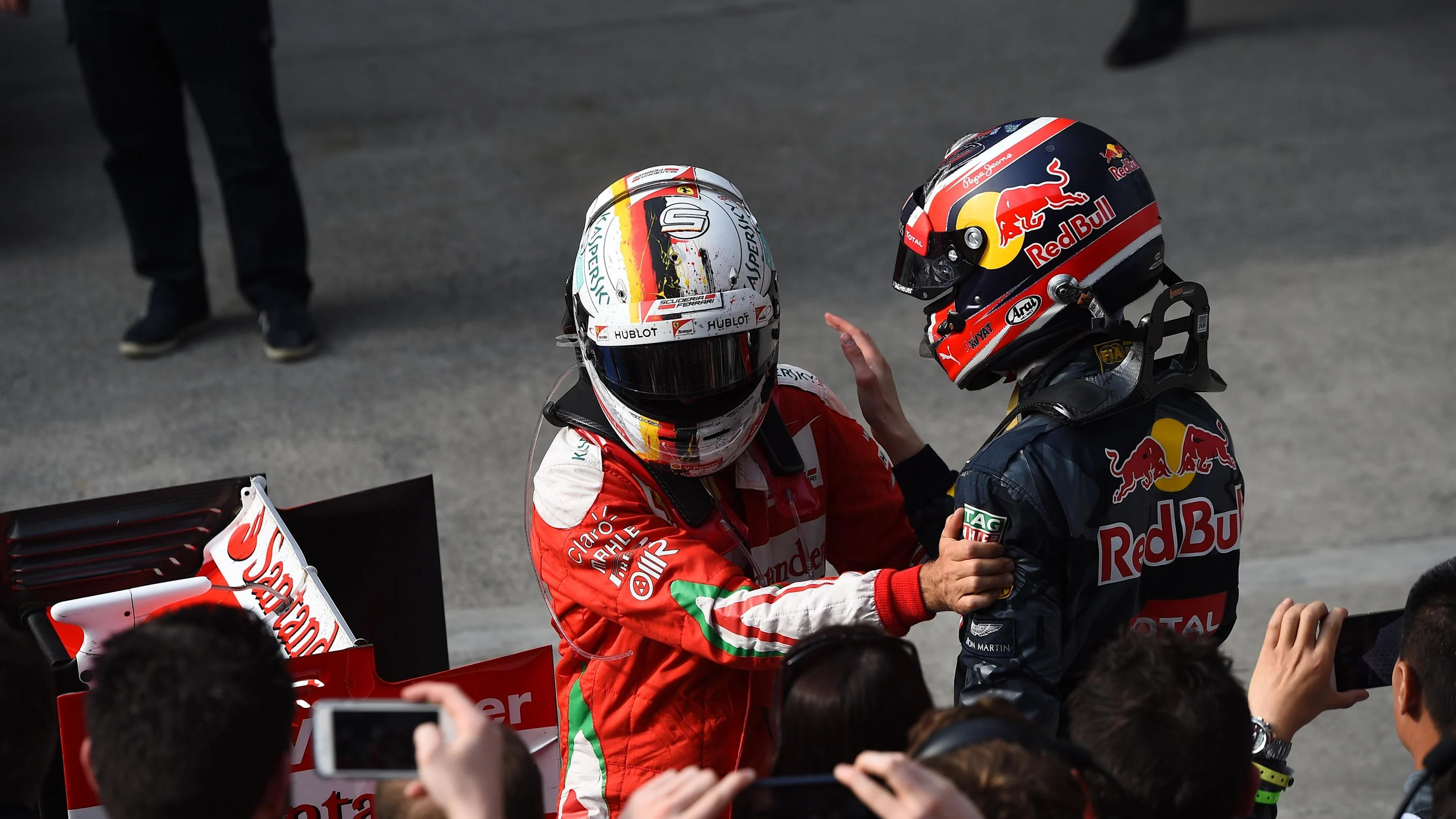 Sebastian Vettel (GER) Ferrari celebrates in parc ferme with Daniil Kvyat (RUS) Red Bull Racing at