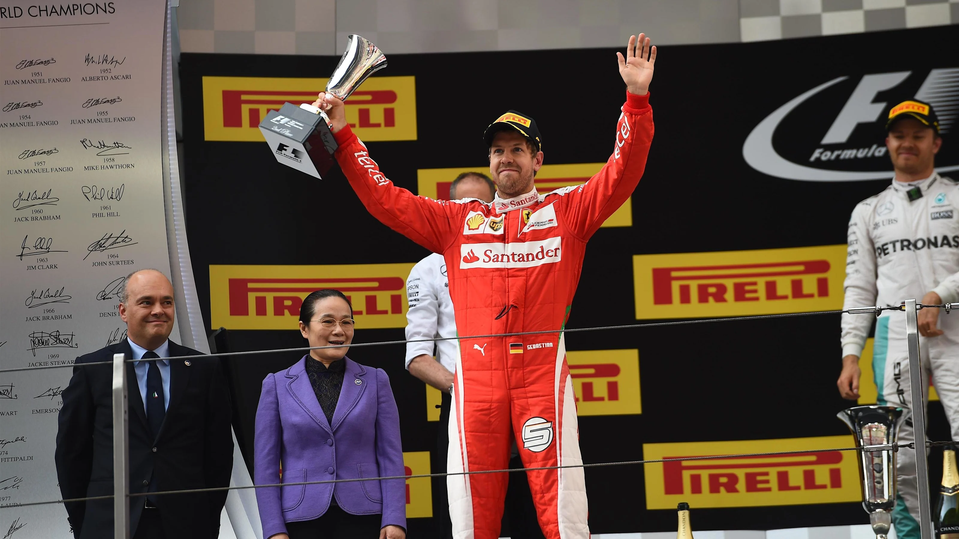 Sebastian Vettel (GER) Ferrari celebrates on the podium with the trophy at Formula One World