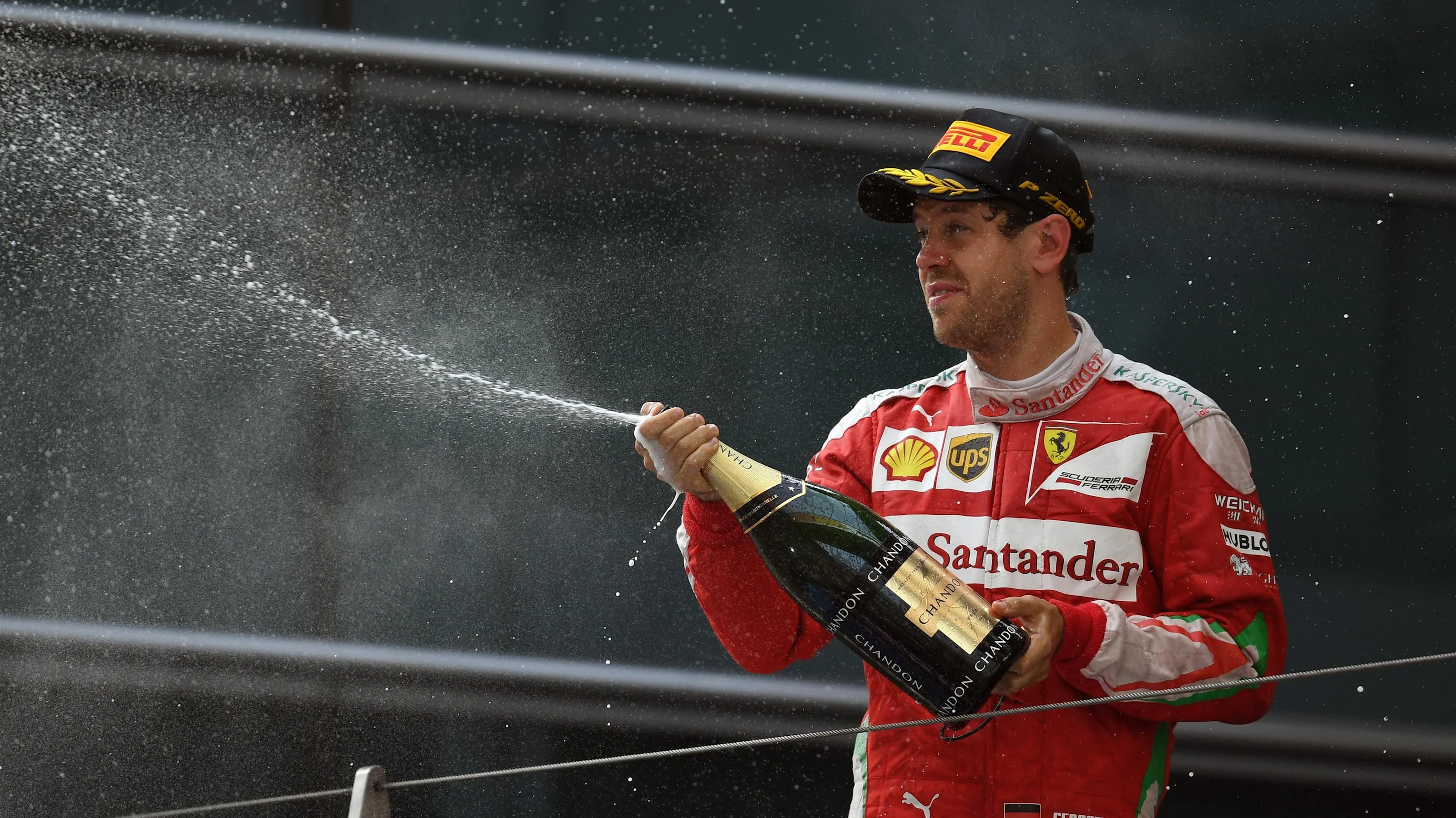 Sebastian Vettel (GER) Ferrari celebrates with the champagne on the podium at Formula One World