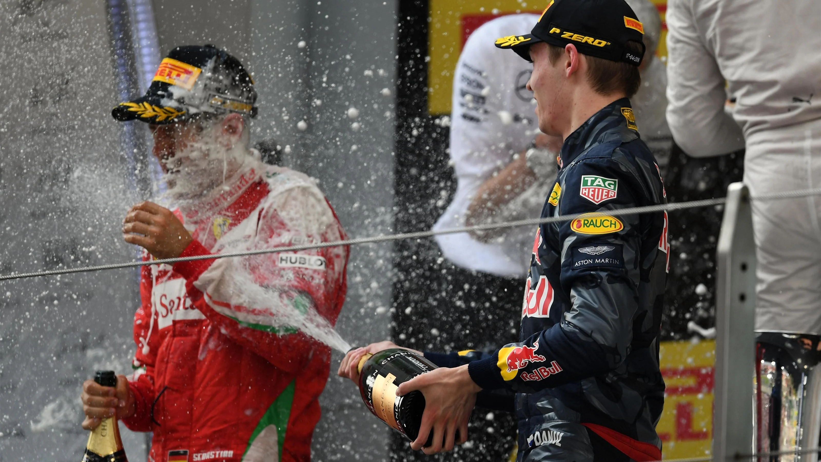 Sebastian Vettel (GER) Ferrari and Daniil Kvyat (RUS) Red Bull Racing celebrate on the podium with