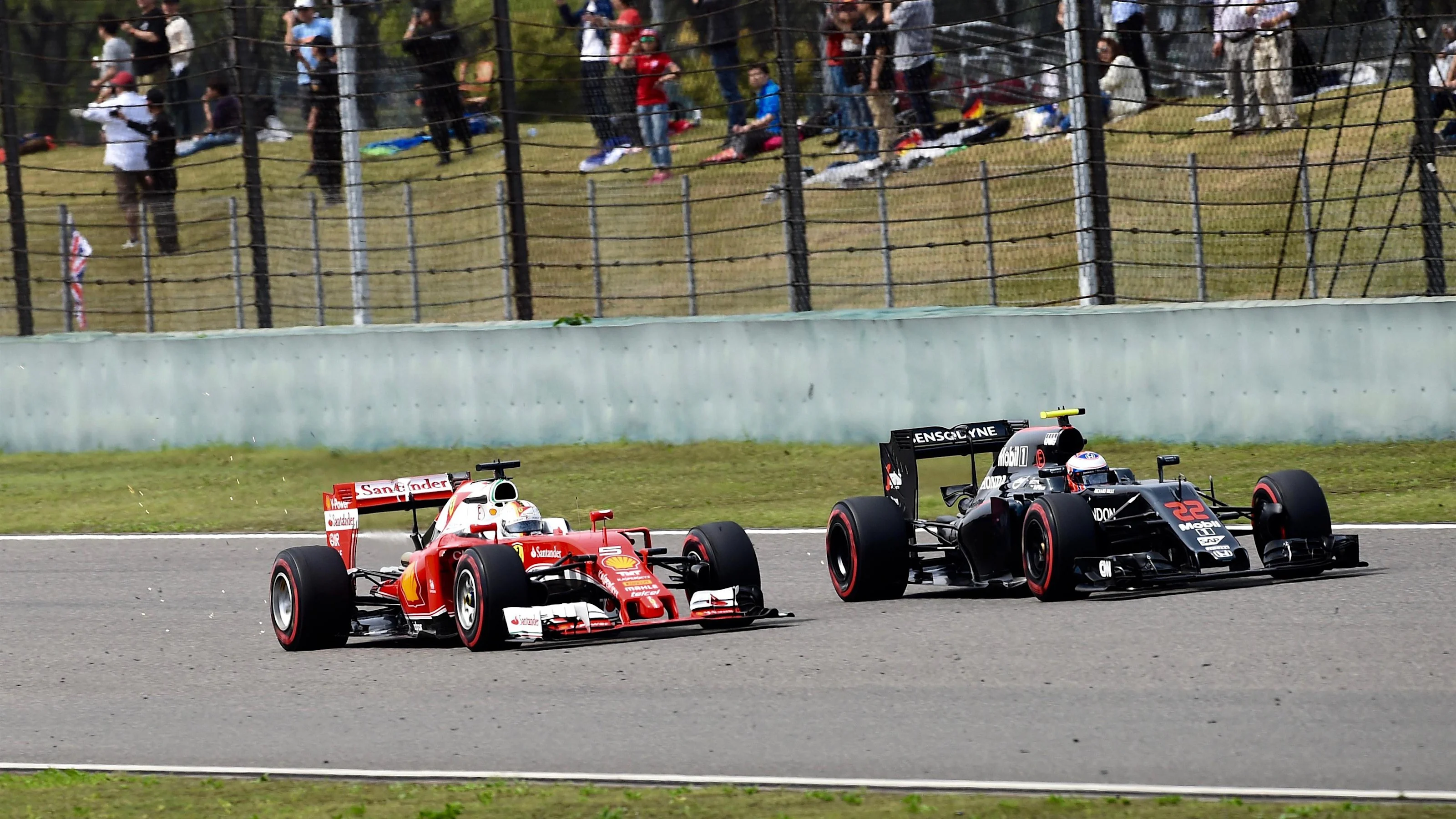 Sebastian Vettel (GER) Ferrari SF16-H and Jenson Button (GBR) McLaren MP4-31 battle at Formula One