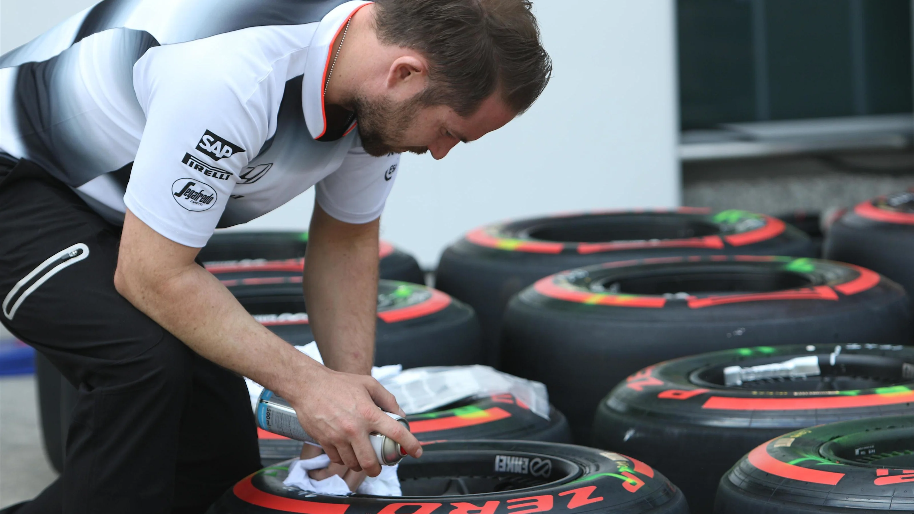 McLaren mechanic marks Pirelli tyres at Formula One World Championship, Rd3, Chinese Grand Prix,