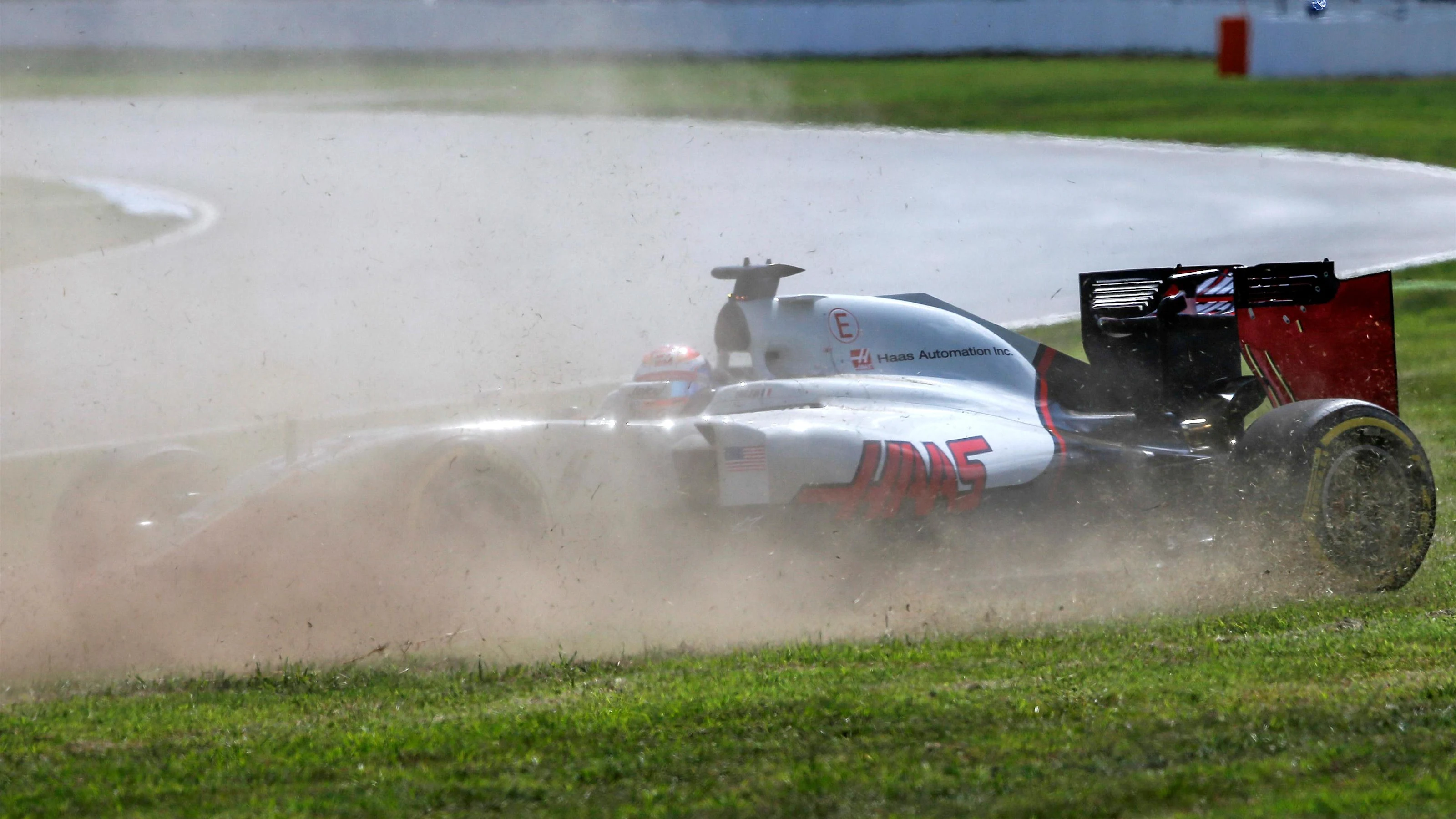 Romain Grosjean (FRA) Haas VF-16 spins accross the grass at Formula One World Championship, Rd12,