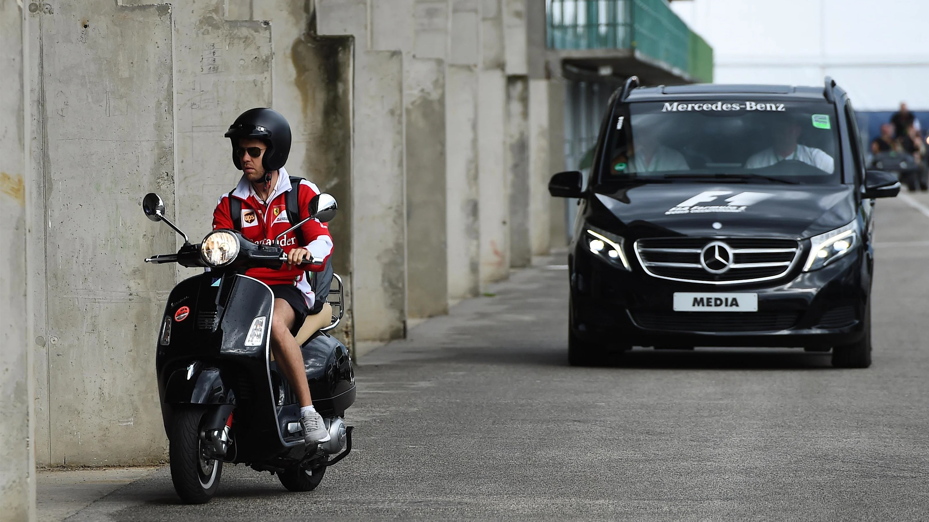 Sebastian Vettel (GER) Ferrari arrives at the track on a scooter at Formula One World Championship,