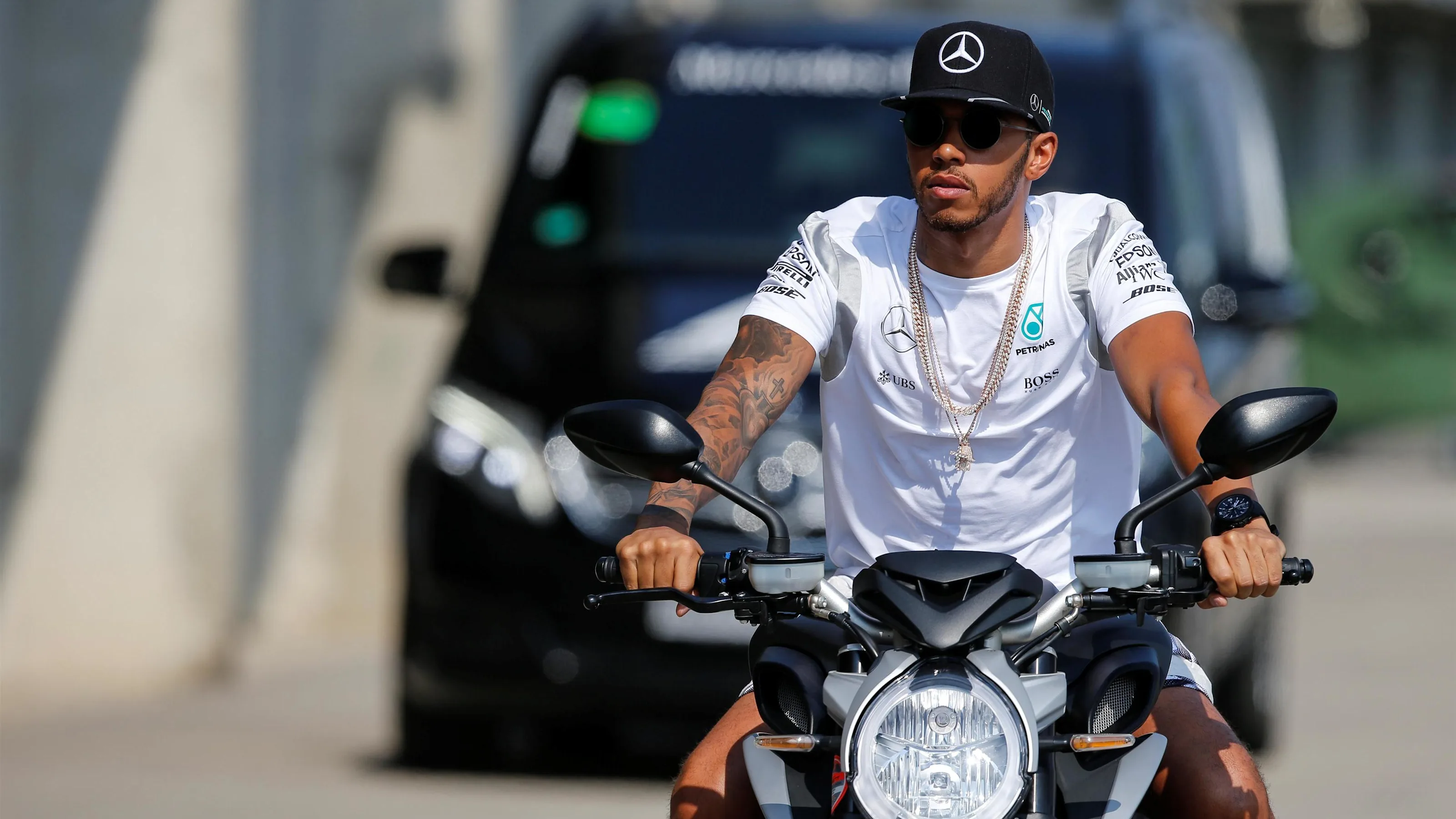 Lewis Hamilton (GBR) Mercedes AMG F1 arrives at the track on a motorbike at Formula One World