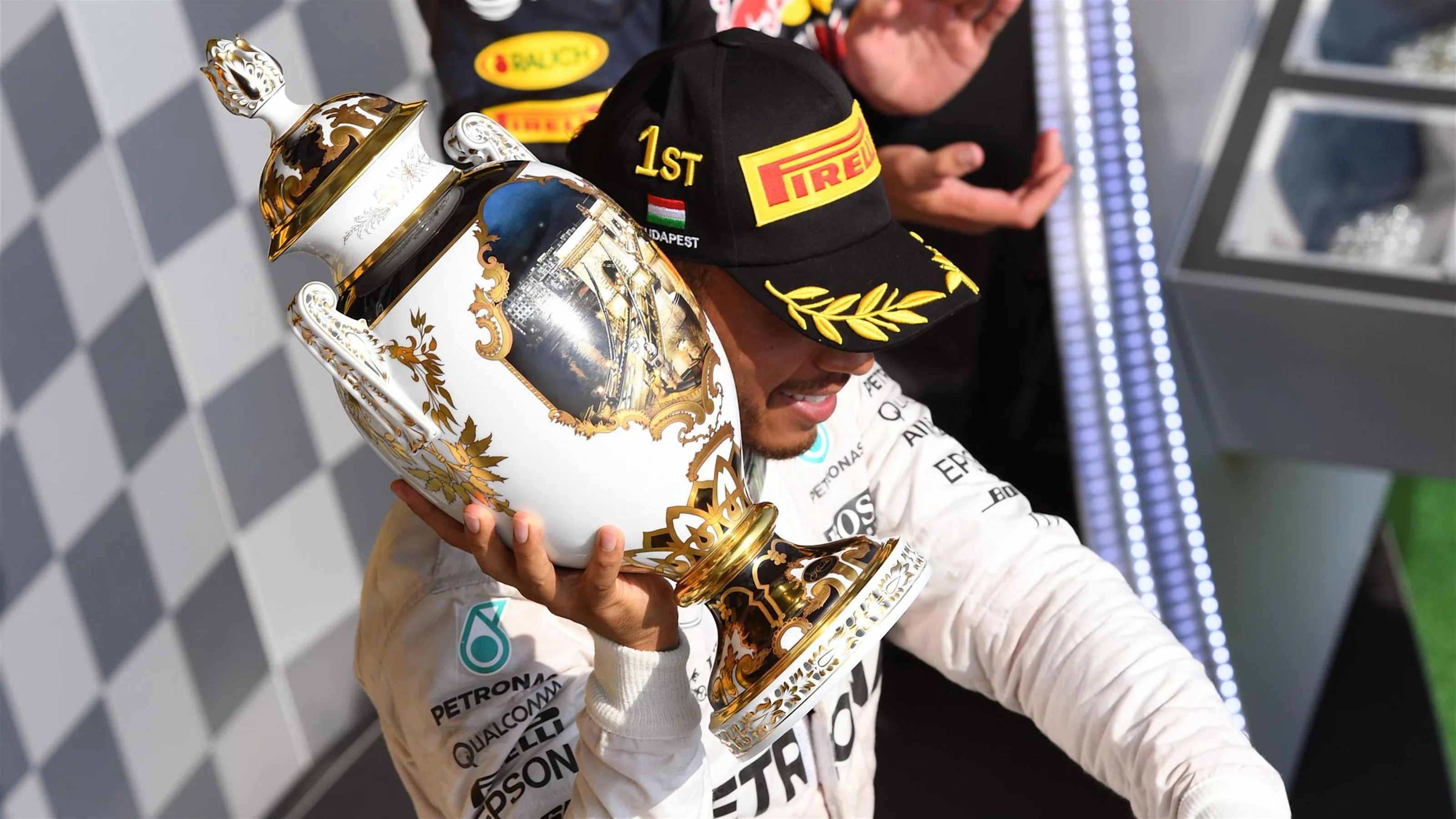 Race winner Lewis Hamilton (GBR) Mercedes AMG F1 celebrates on the podium with the trophy at
