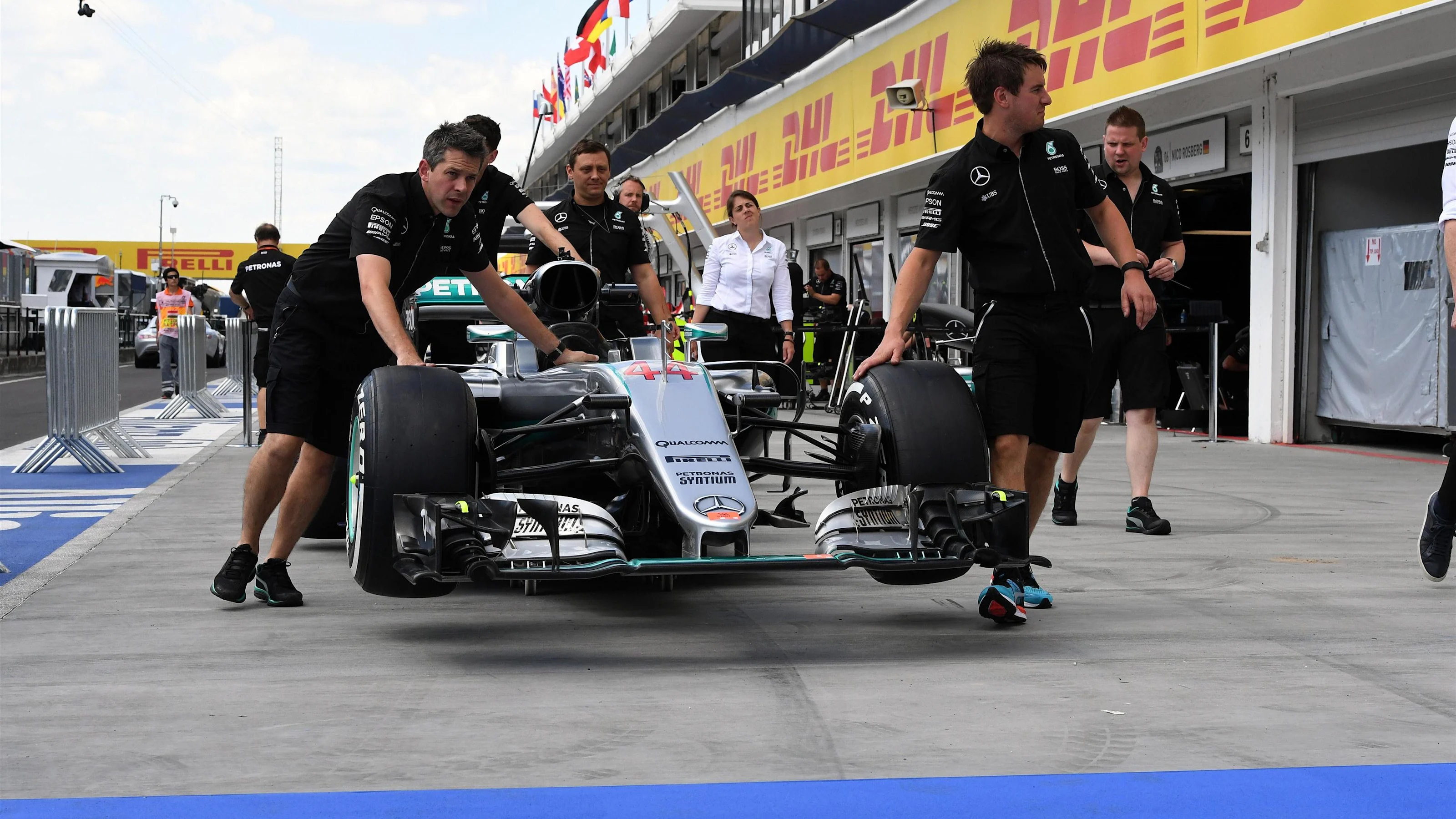 Mercedes AMG F1 mechanics with Mercedes-Benz F1 W07 Hybrid in pit lane at Formula One World