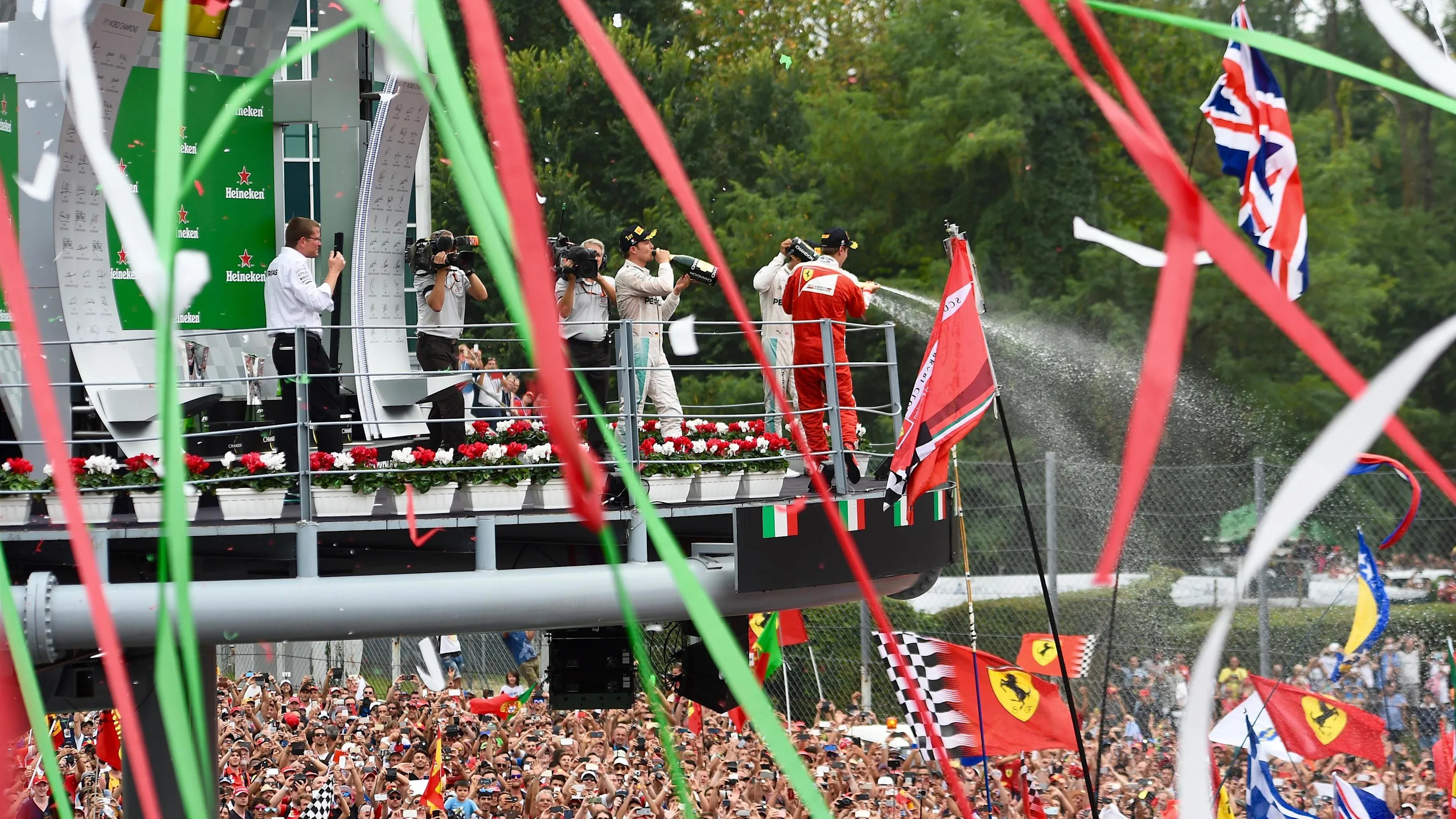 Race winner Nico Rosberg (GER) Mercedes AMG F1 ceebrates with champagne on the podium alongside