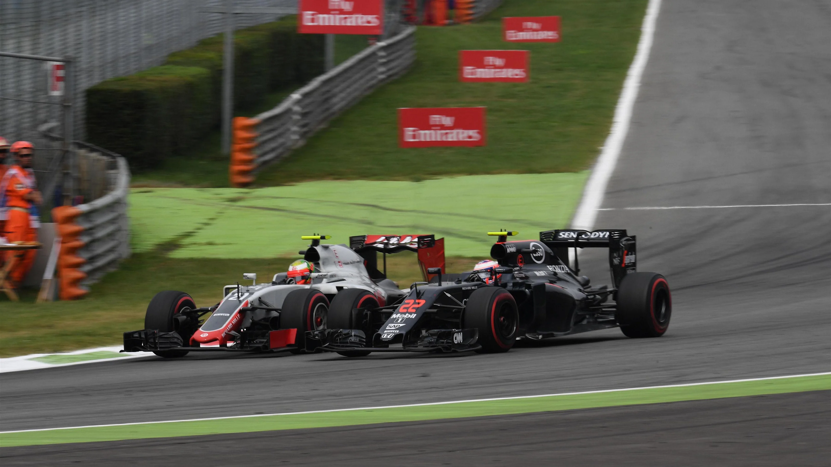 Esteban Gutierrez (MEX) Haas VF-16 and Jenson Button (GBR) McLaren MP4-31 battle at Formula One