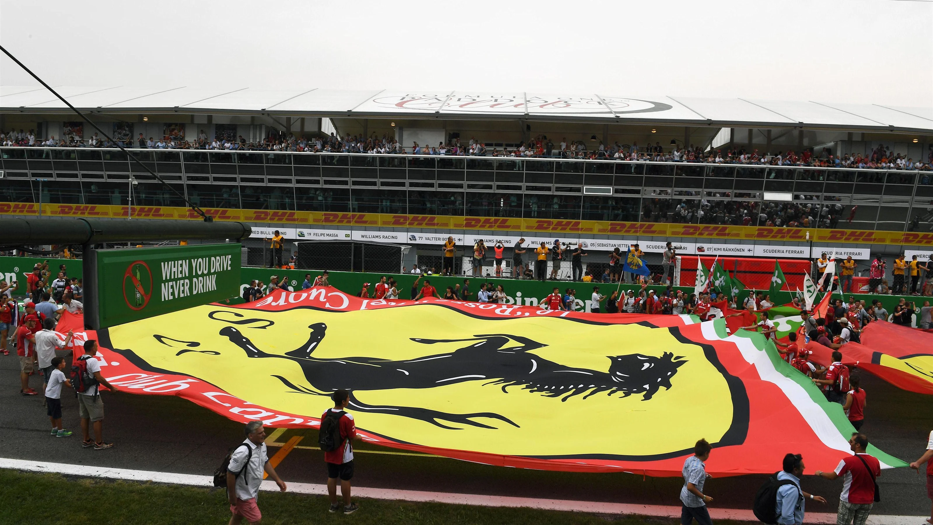 Fans and giant Ferrari flag on track at Formula One World Championship, Rd14, Italian Grand Prix,
