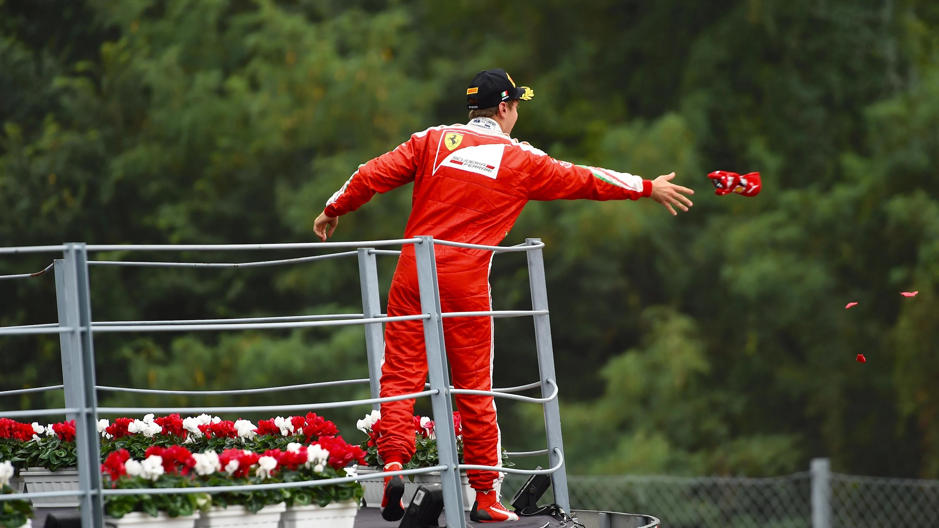 Sebastian Vettel (GER) Ferrari celebrates on the podium and throws his cap at Formula One World