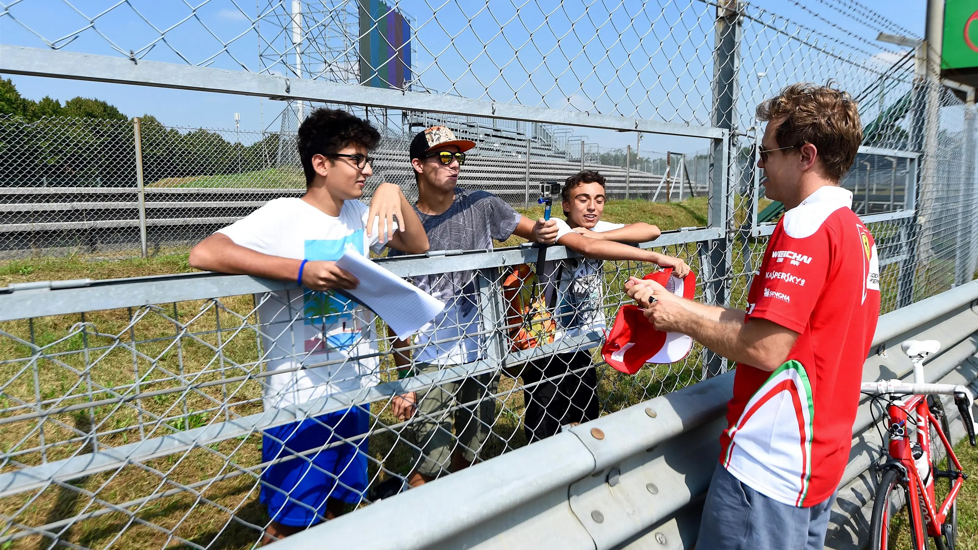 Sebastian Vettel (GER) Ferrari and fans and bike at Formula One World Championship, Rd14, Italian