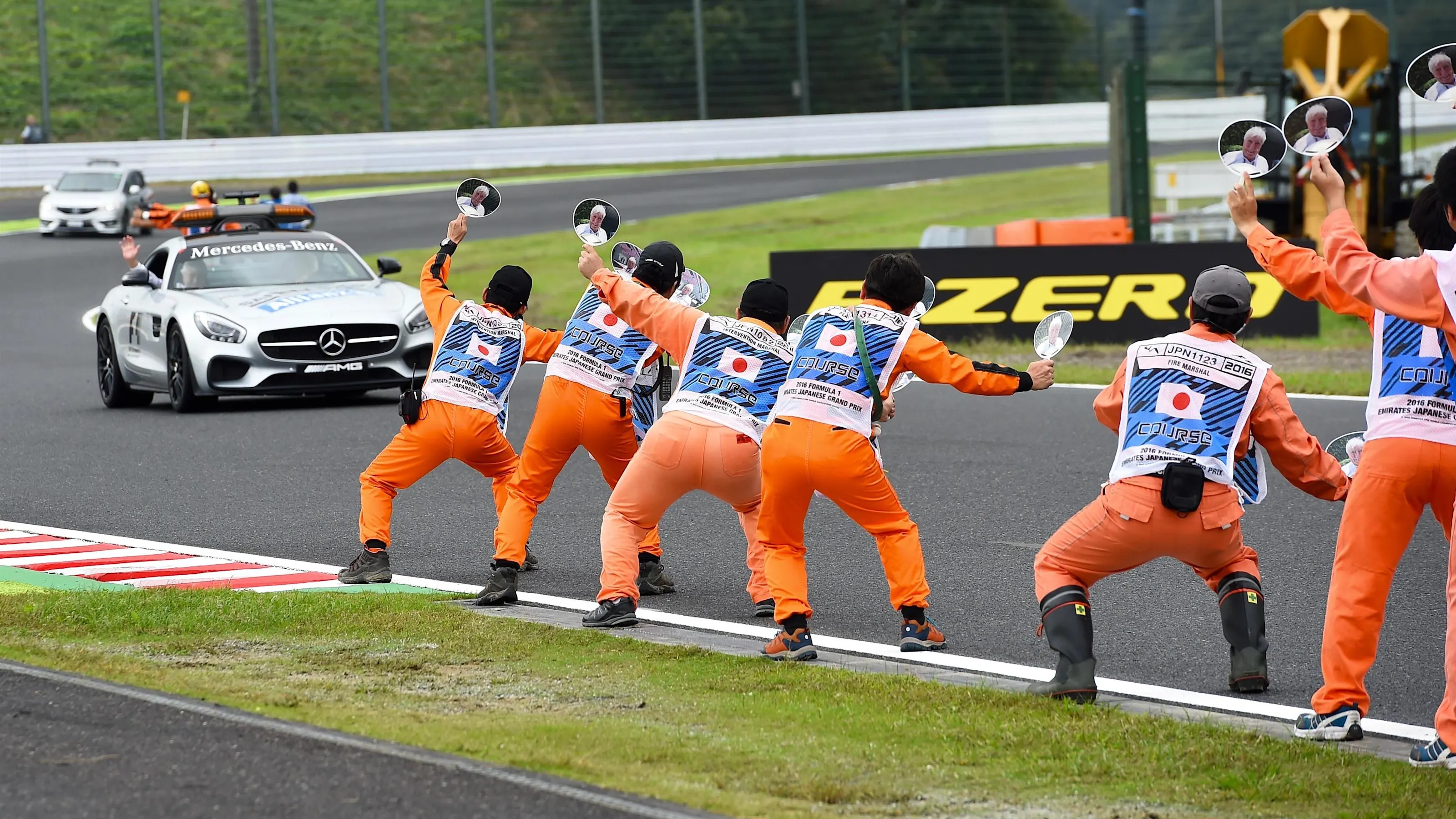 Marshals wave banners for Herbie Blash (GBR) FIA Delegate at the safety car at Formula One World