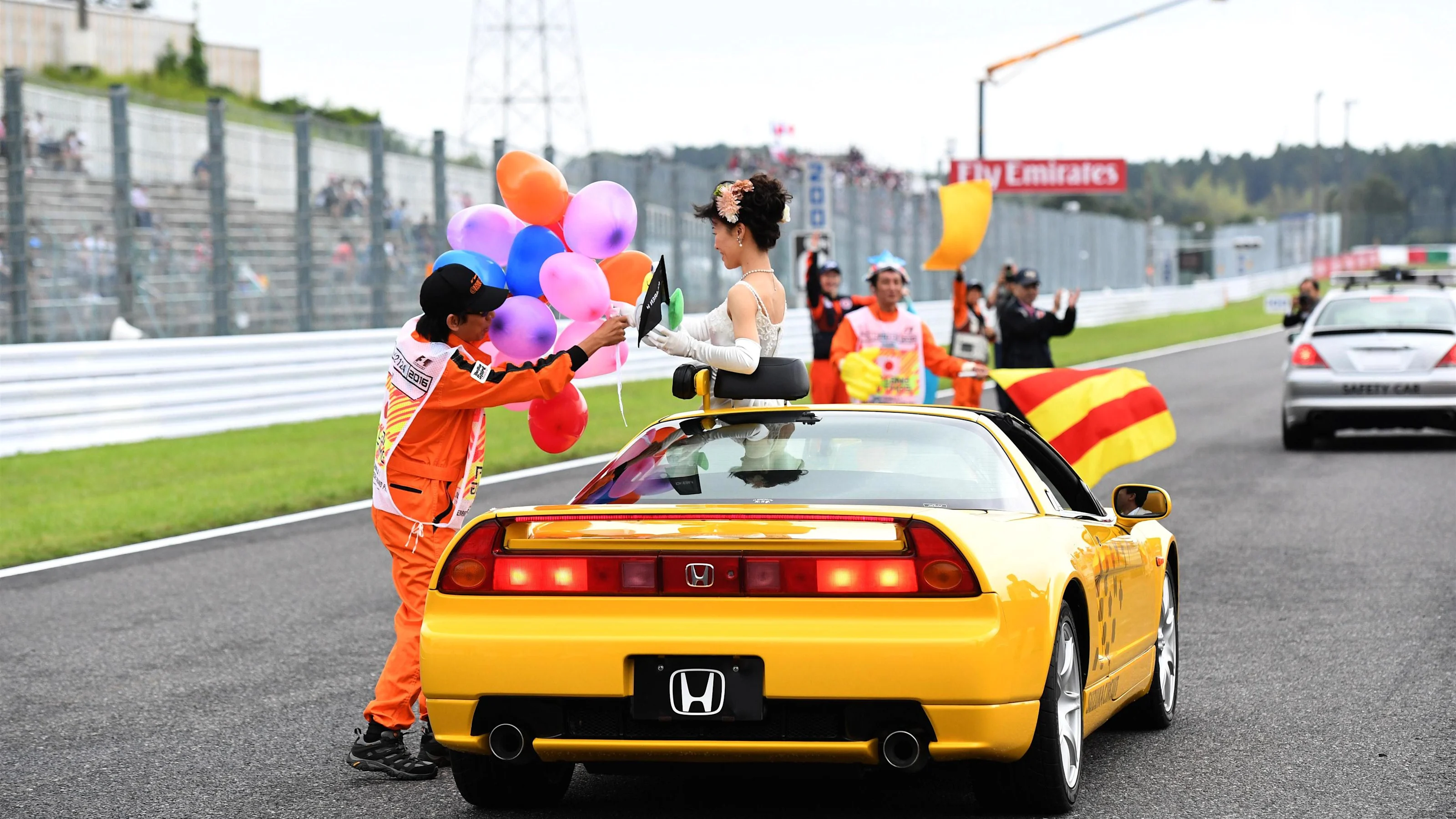 Girl and marshals at Formula One World Championship, Rd17, Japanese Grand Prix, Qualifying, Suzuka,