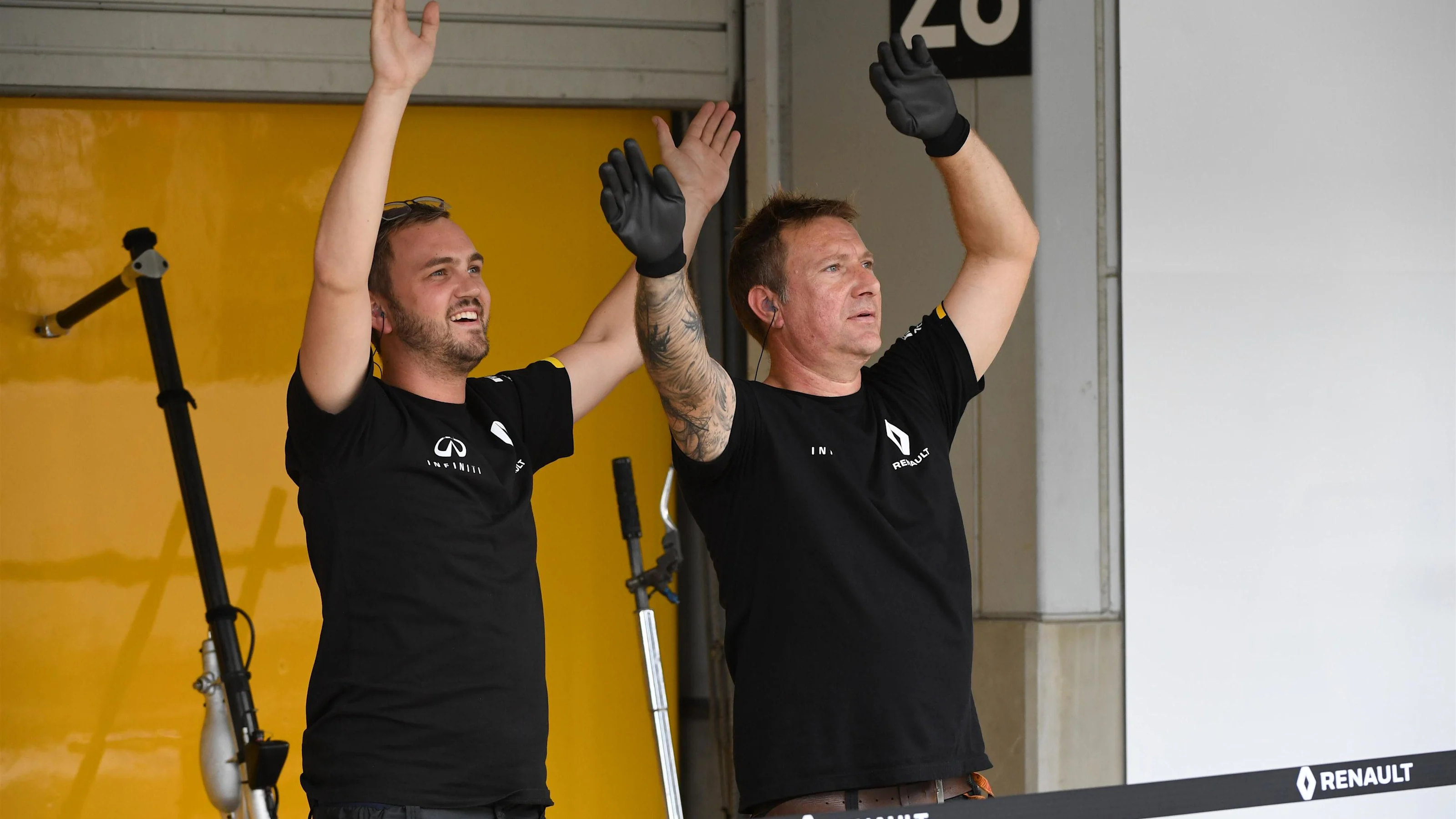 Renault Sport F1 Team mechanics react with fans at Formula One World Championship, Rd17, Japanese