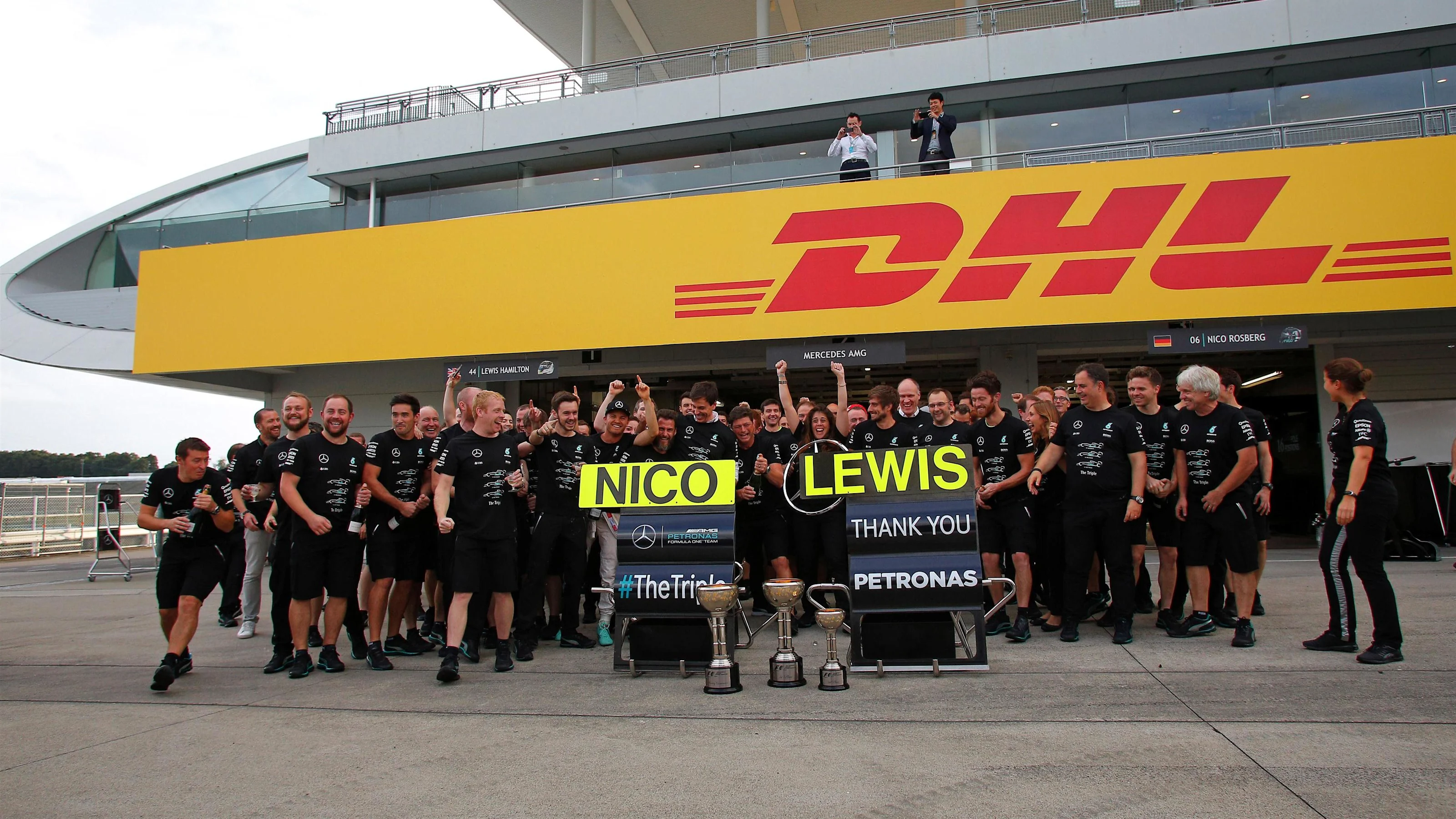 Mercedes AMG F1 mechanics and engineers celebrate the constructors championship with the trophy at