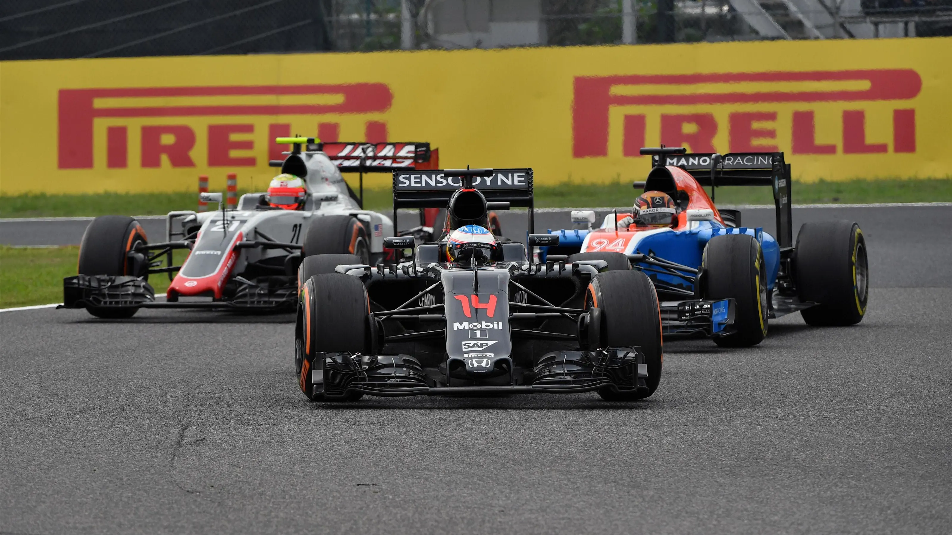 Fernando Alonso (ESP) McLaren MP4-31, Pascal Wehrlein (GER) Manor Racing MRT05 and Esteban