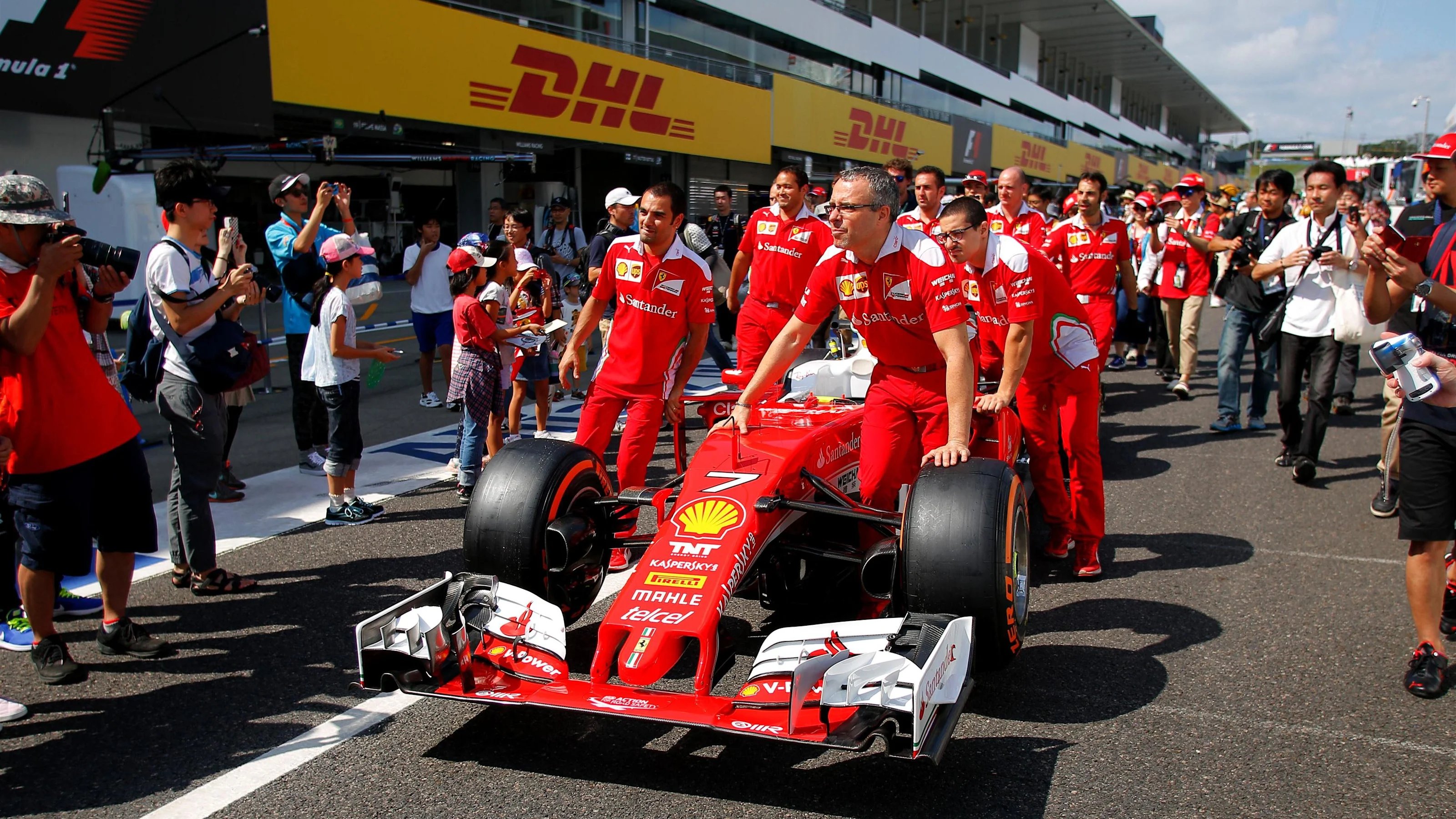 Ferrari mechanics with Ferrari SF16-H in pit lane at Formula One World Championship, Rd17, Japanese