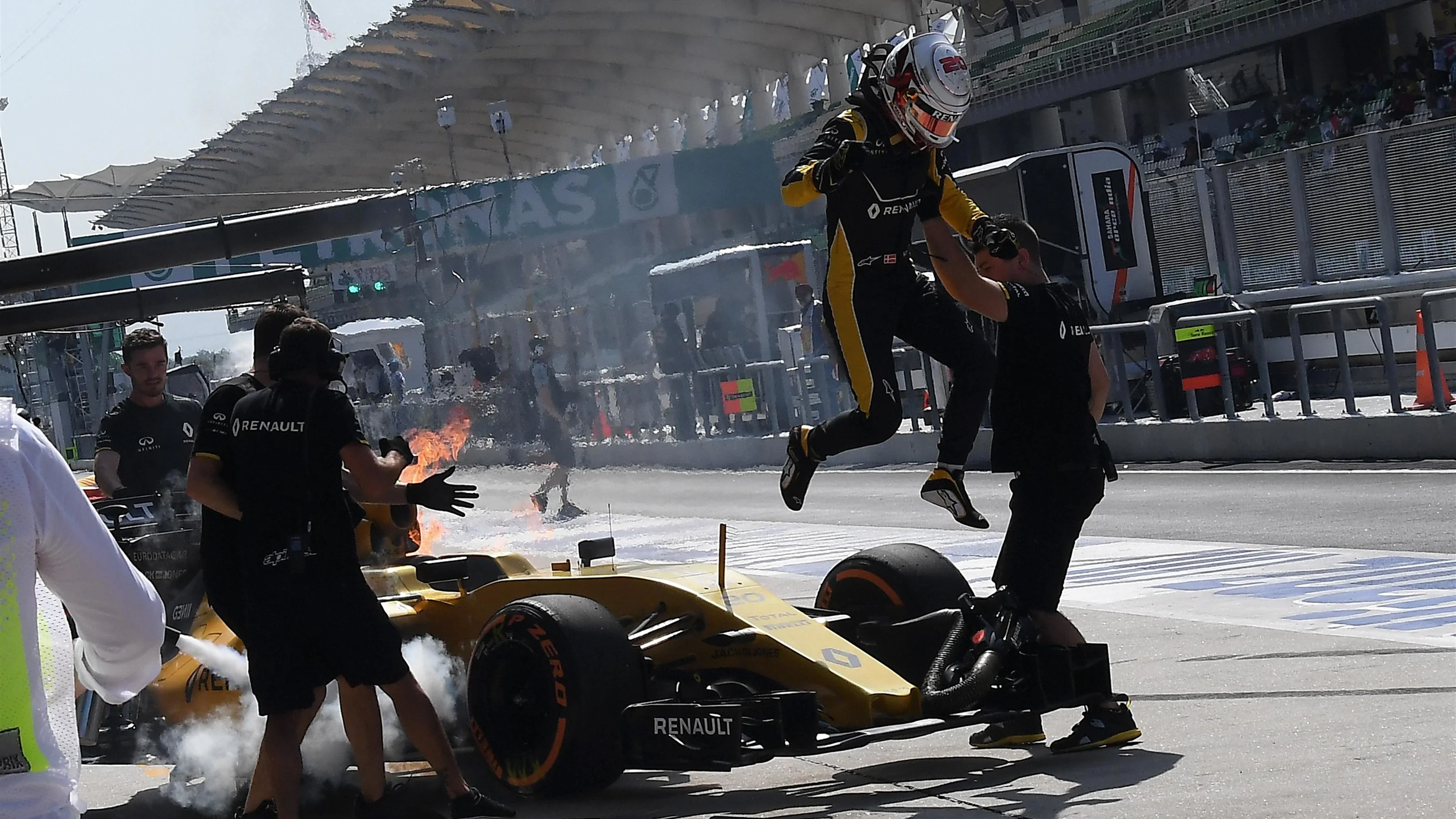 Kevin Magnussen (DEN) Renault Sport F1 Team RS16 leaps from his on fire car in FP1 at Formula One
