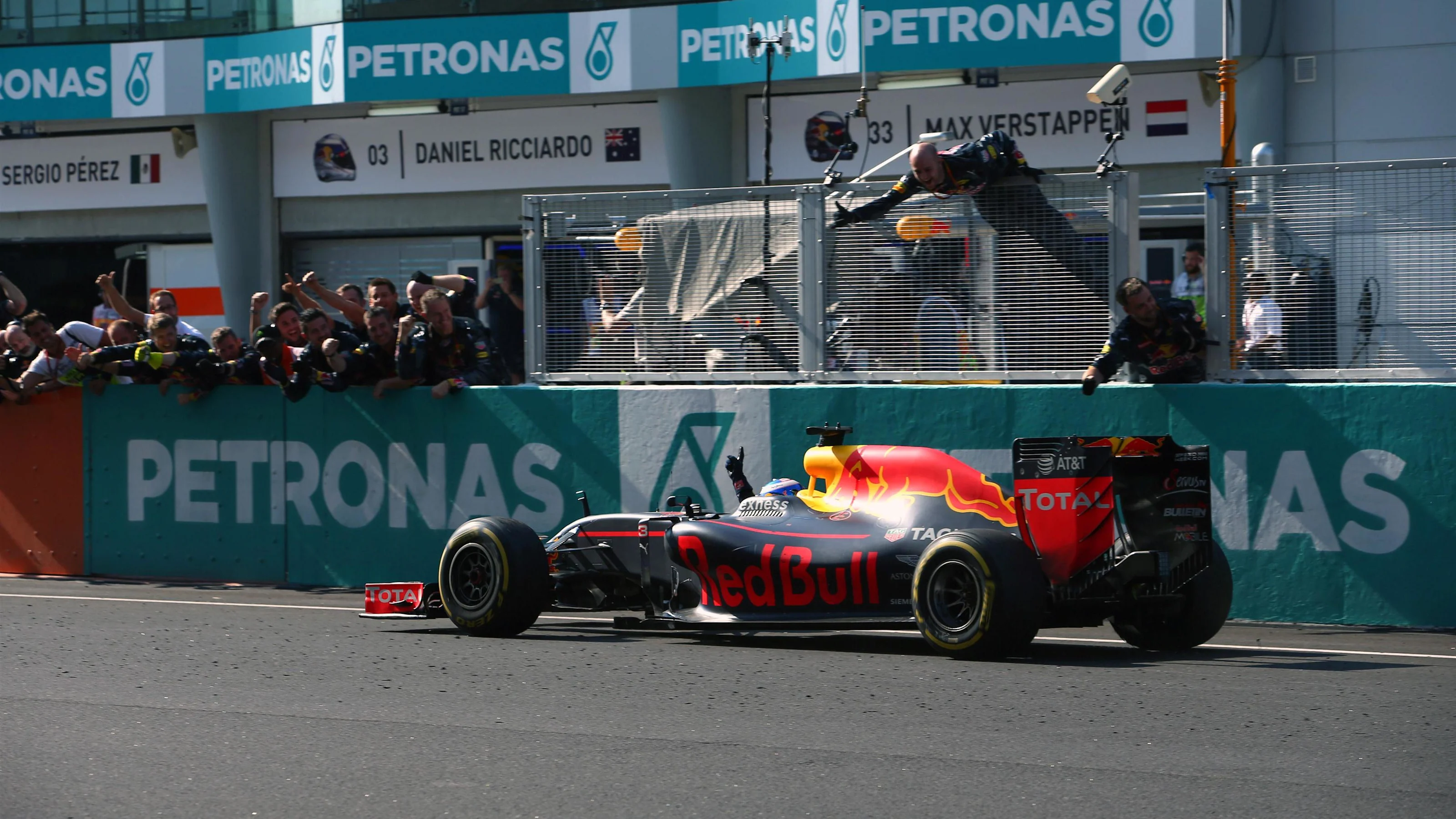 Race winner Daniel Ricciardo (AUS) Red Bull Racing RB12 crosses the line to win the race and