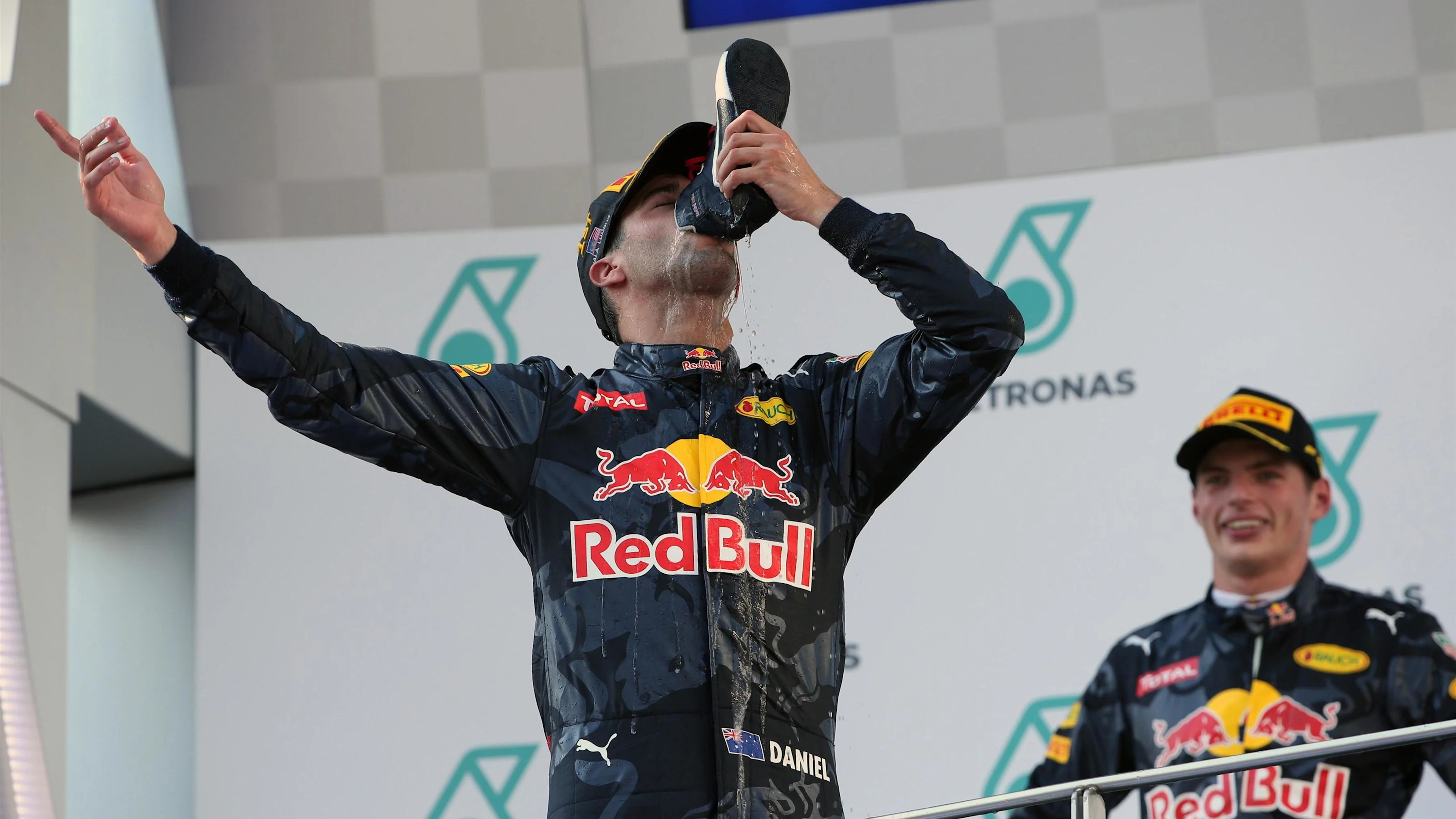 Race winner Daniel Ricciardo (AUS) Red Bull Racing celebrates on the podium and drinks champagne