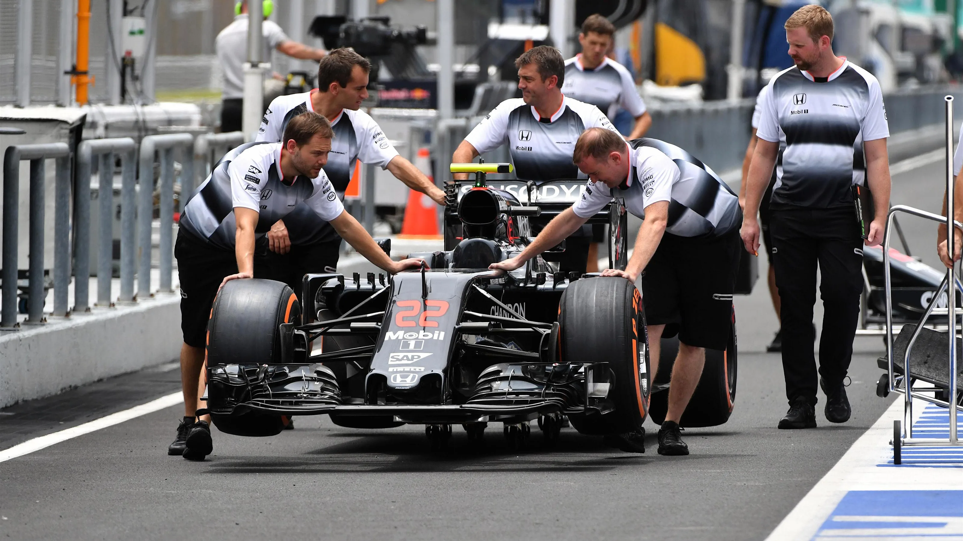 McLaren mechanics with McLaren MP4-31 in pit lane at Formula One World Championship, Rd16,