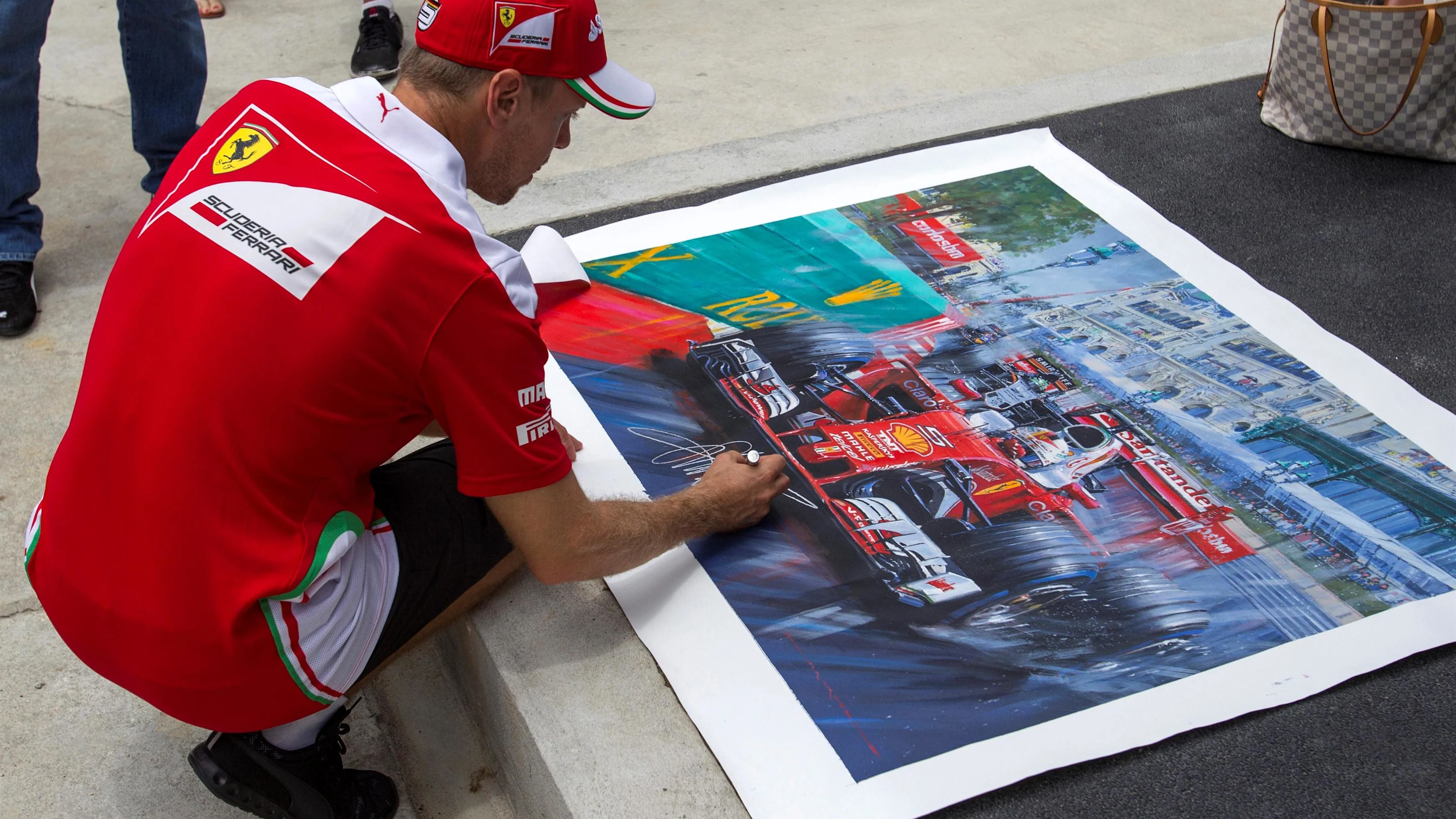 Sebastian Vettel (GER) Ferrari signs a painting at Formula One World Championship, Rd16, Malaysian