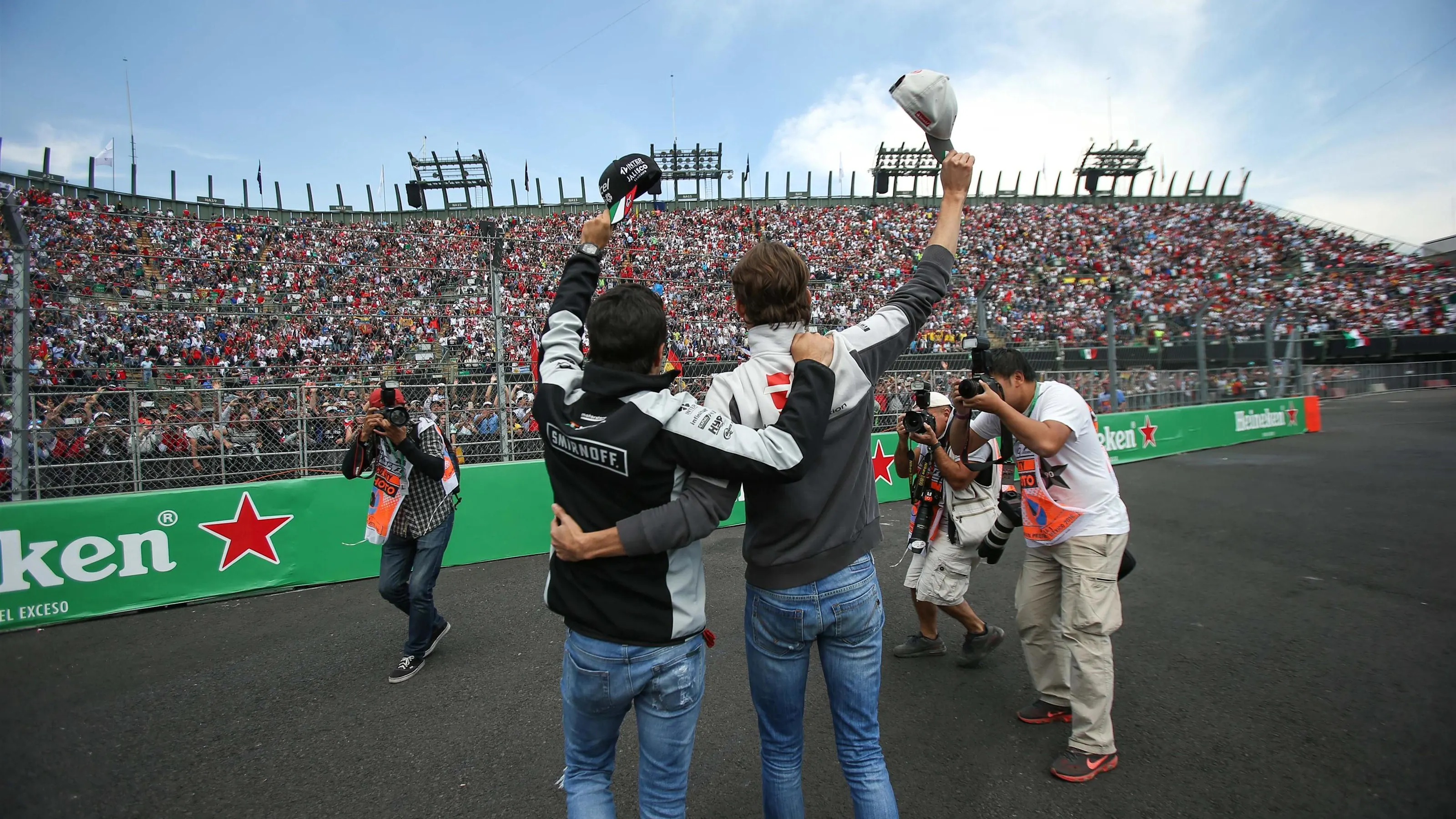 Sergio Perez (MEX) Force India and Esteban Gutierrez (MEX) Haas F1 wave to the fans on the drivers
