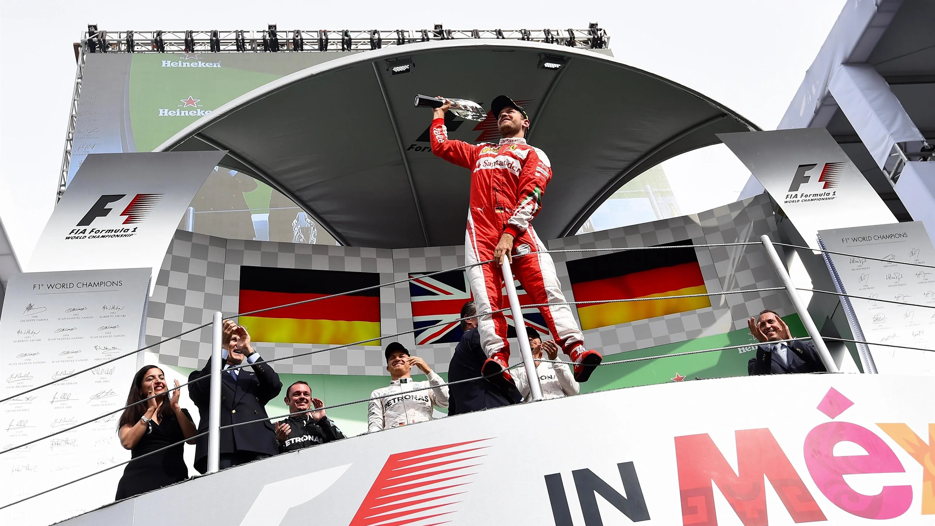 Sebastian Vettel (GER) Ferrari celebrates on the podium with the trophy at Formula One World