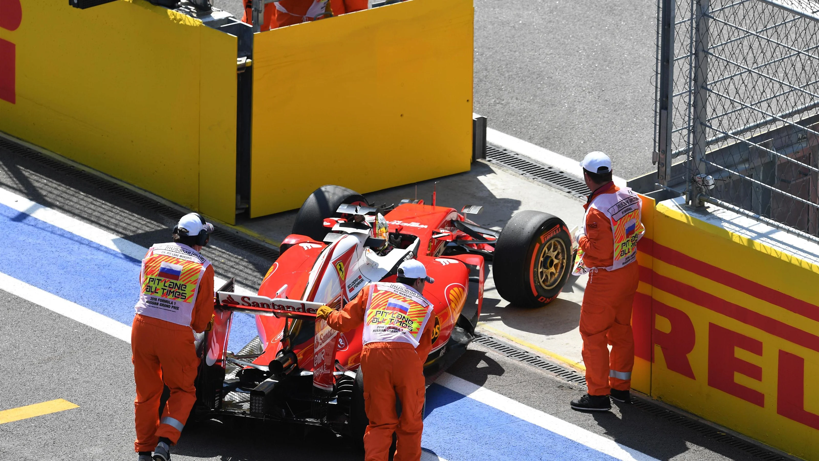 The car of Sebastian Vettel (GER) Ferrari SF16-H is pushed into pit lane by the marshals in FP2 at
