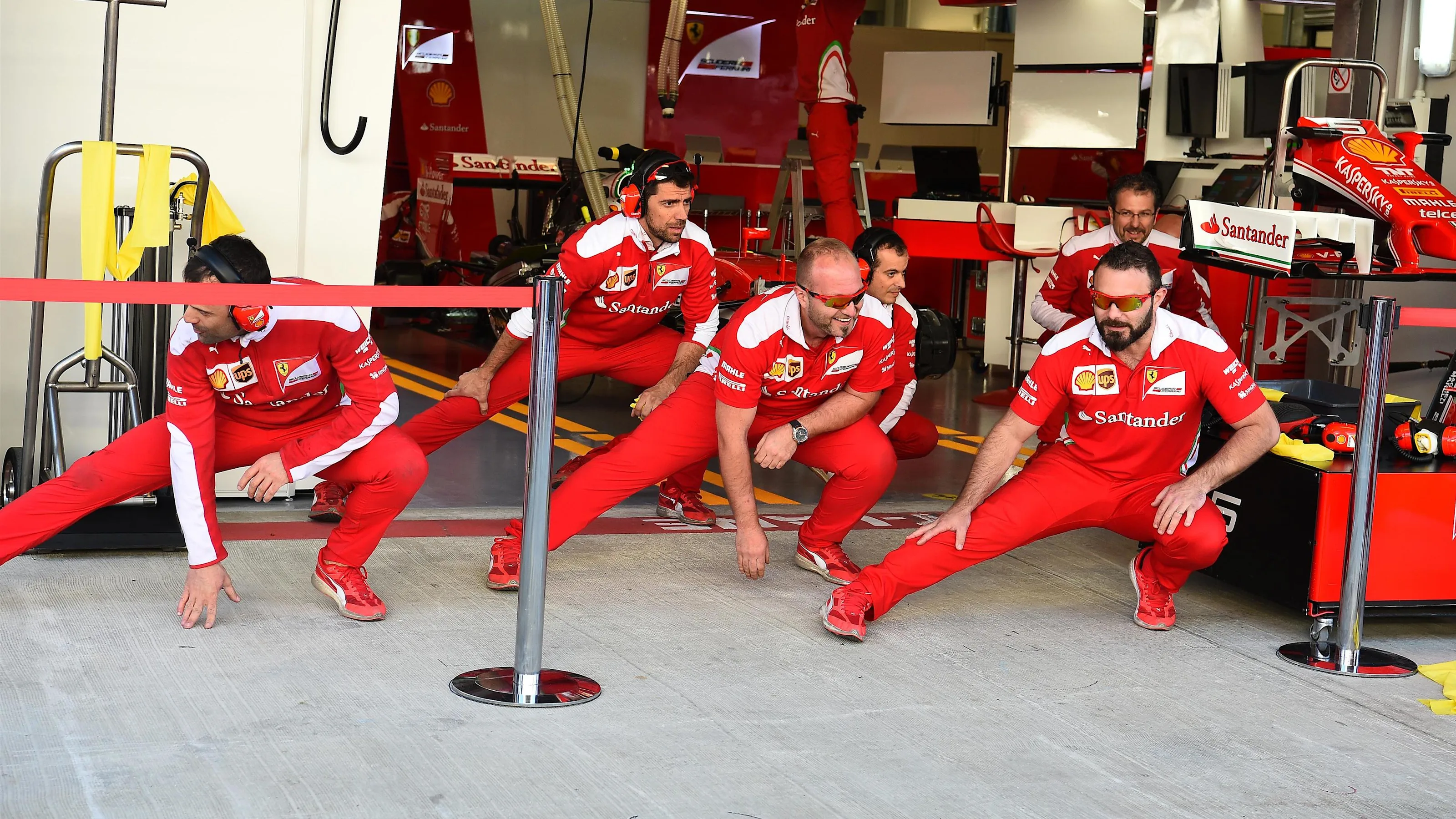 Ferrari mechanics perform warm up exercises at Formula One World Championship, Rd4, Russian Grand