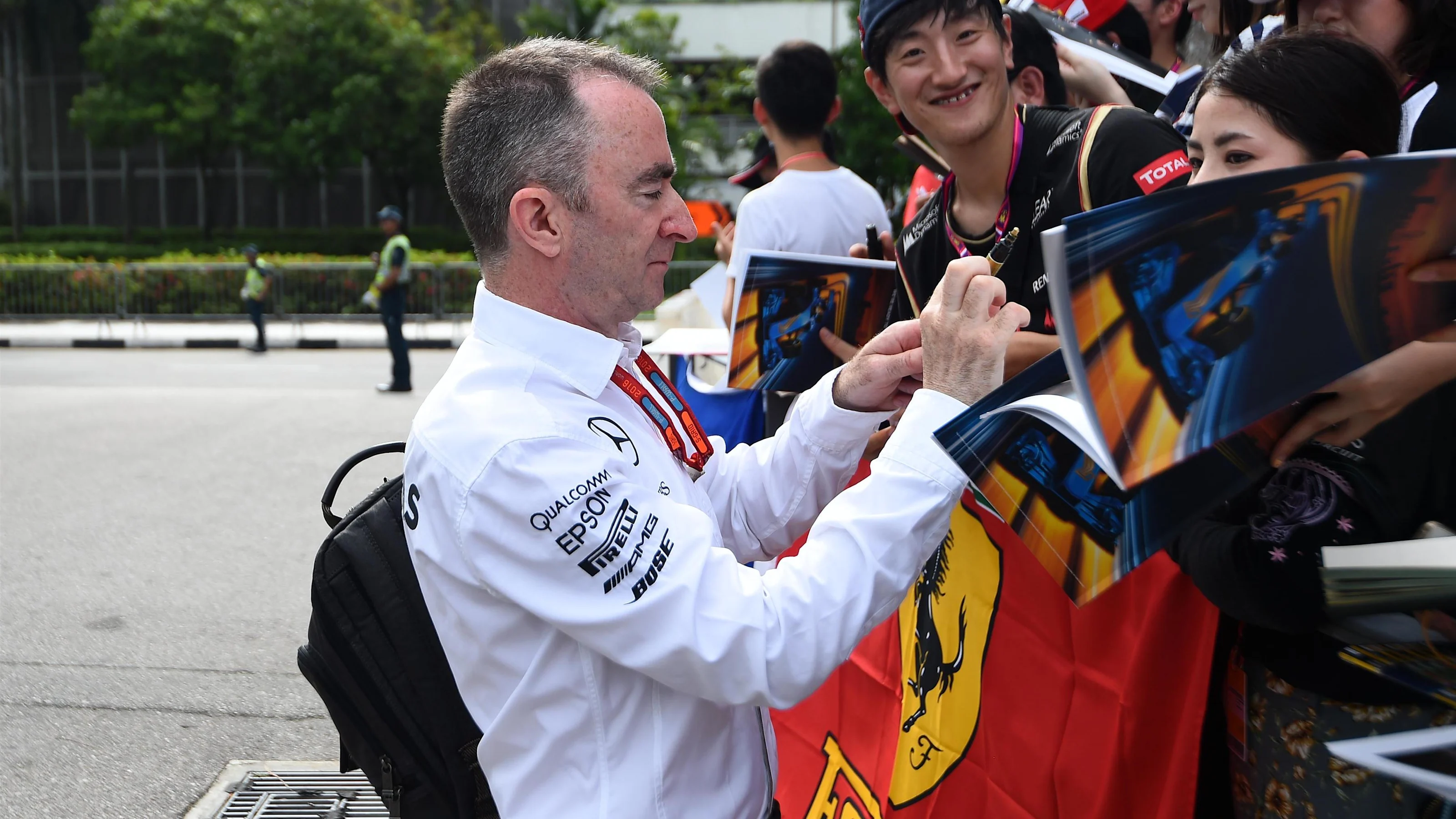Paddy Lowe (GBR) Mercedes AMG F1 Executive Director (Technical) signs autographs for the fans at