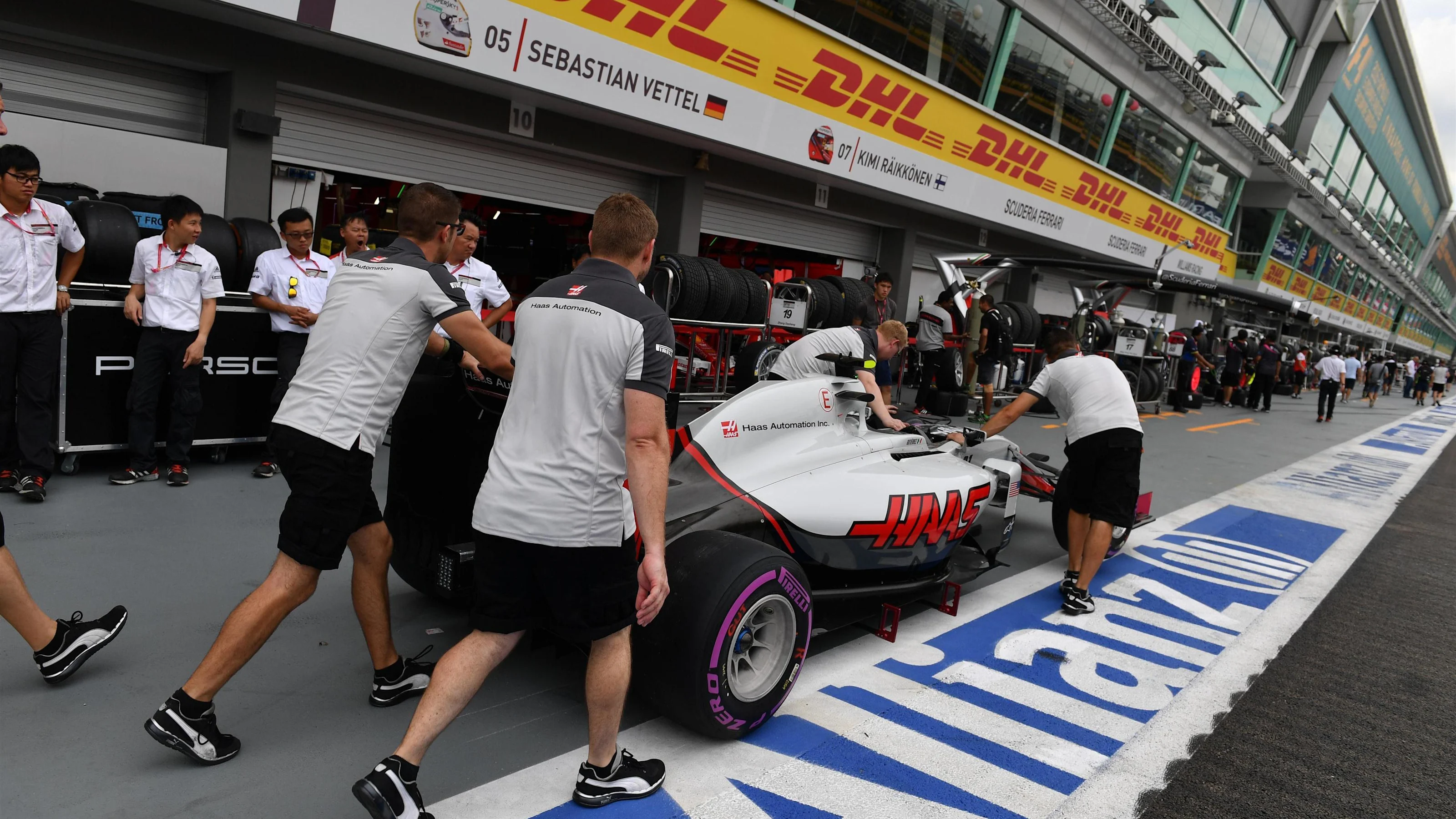 Haas VF-16 with Haas F1 mechanics in pit lane at Formula One World Championship, Rd15, Singapore