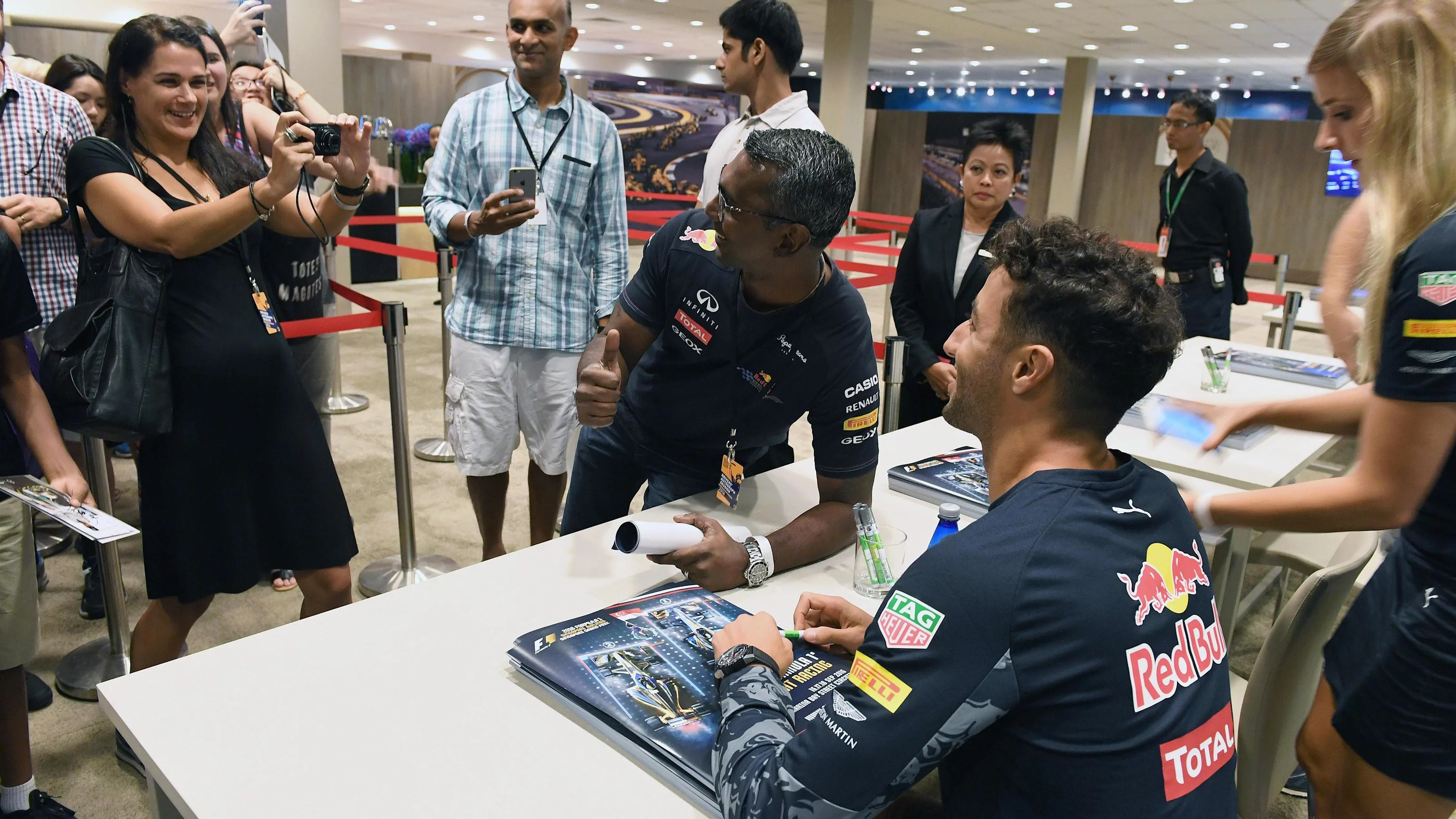 Daniel Ricciardo (AUS) Red Bull Racing selfie at the fans autograph session at Formula One World