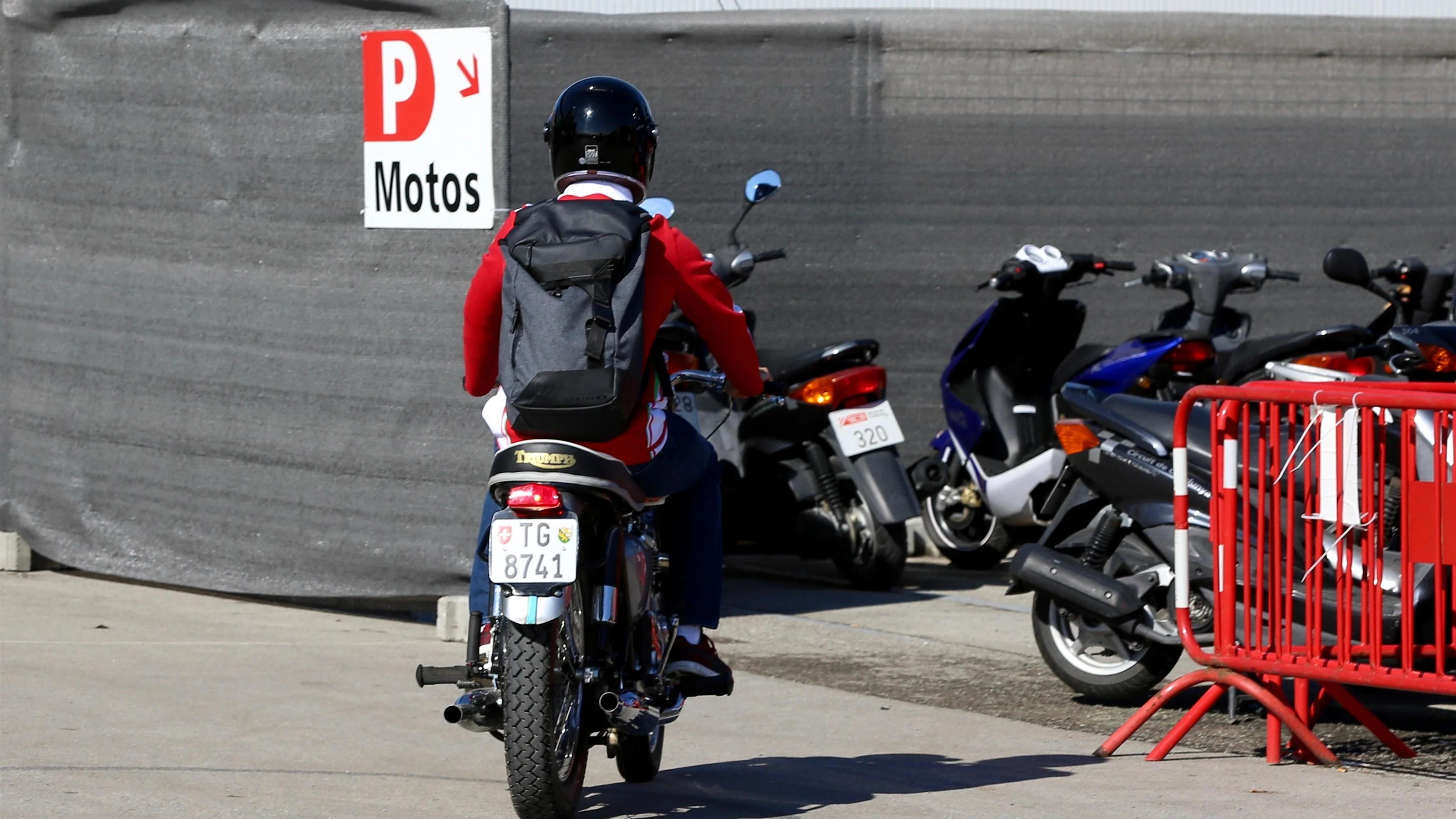 Sebastian Vettel (GER) Ferrari arrives on a Triumph motorbike at Formula One World Championship,