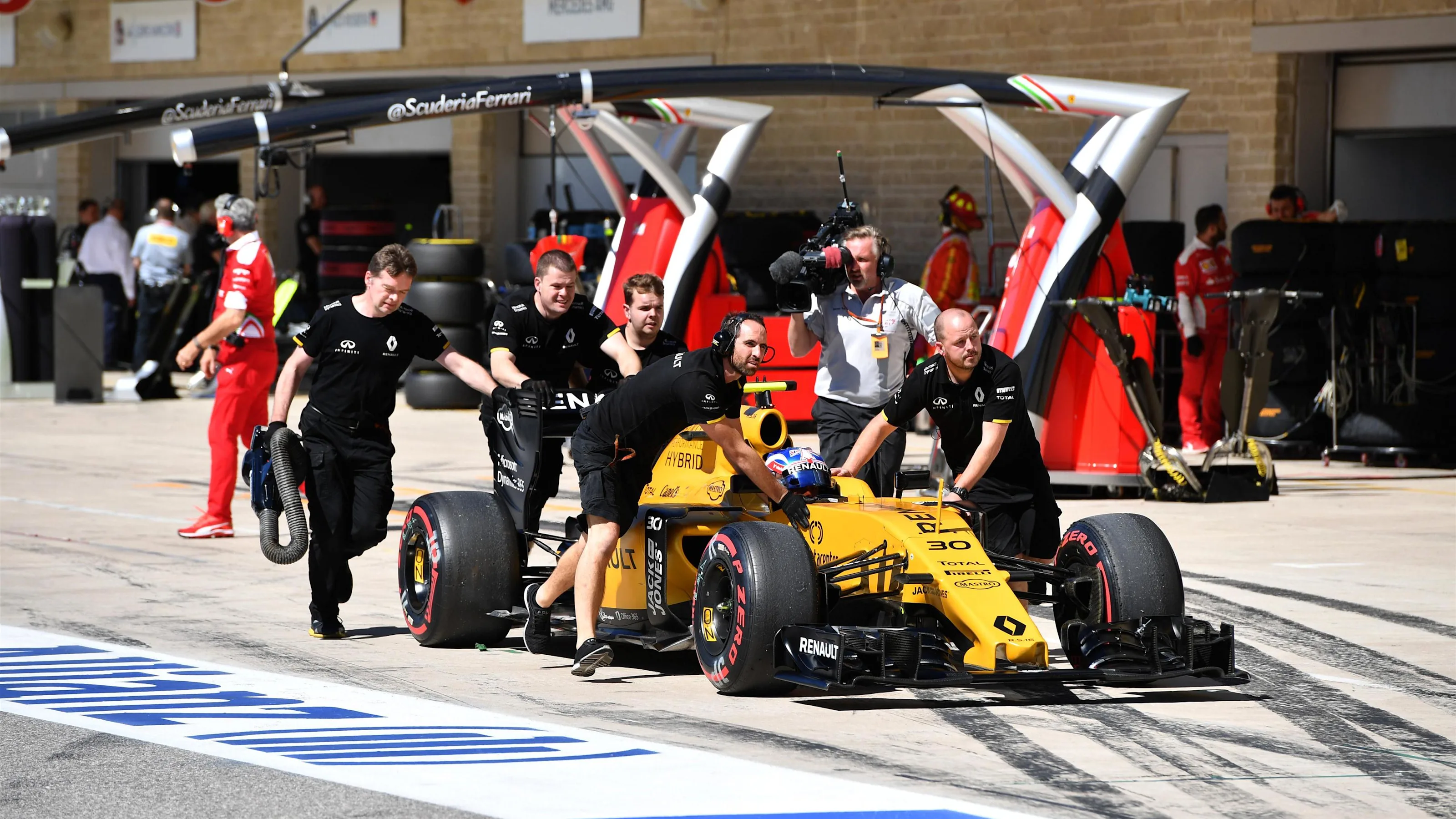 Jolyon Palmer (GBR) Renault Sport F1 Team RS16 is pushed by the mechanics in pit lane at Formula
