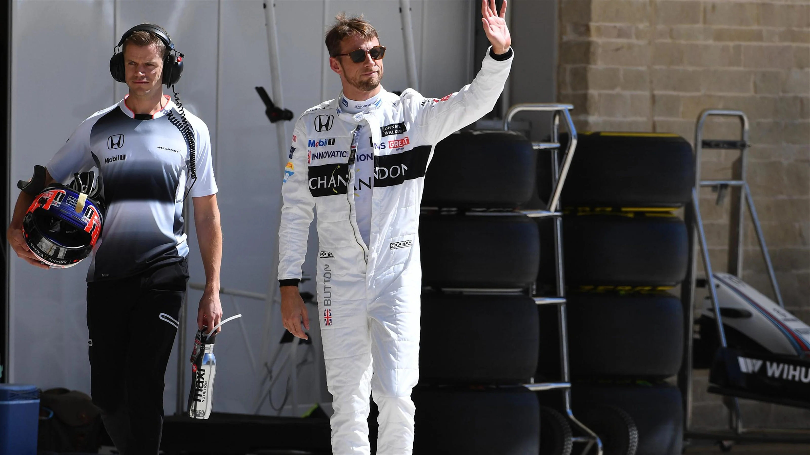 Jenson Button (GBR) McLaren with his trainer Mike Collier (GBR)  waves to the crowd after Q1 at