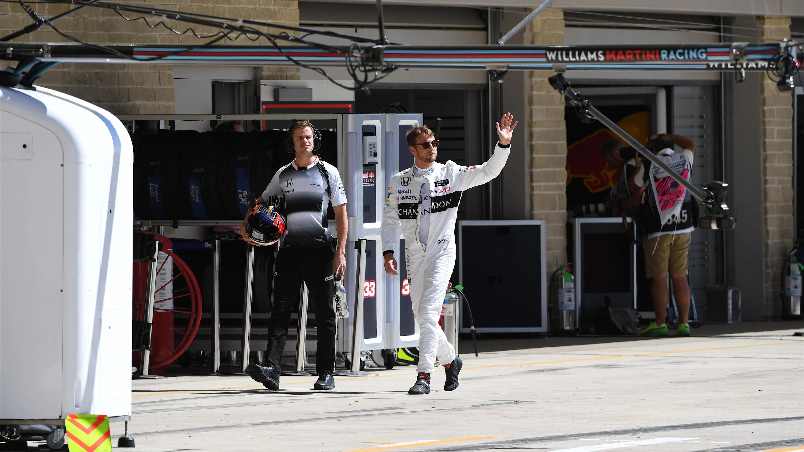 Jenson Button (GBR) McLaren with his trainer Mike Collier (GBR) waves to the crowd after Q1 at